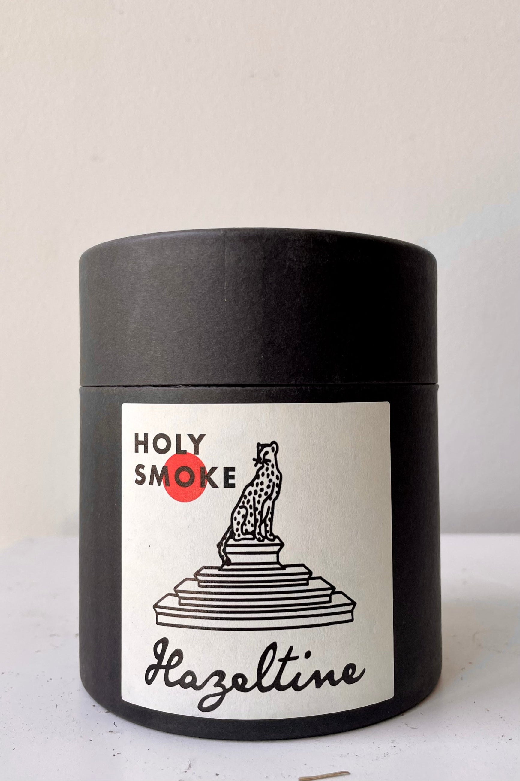 Hazeltine Holy Smoke candle packaging from the front. ©Sprout Home