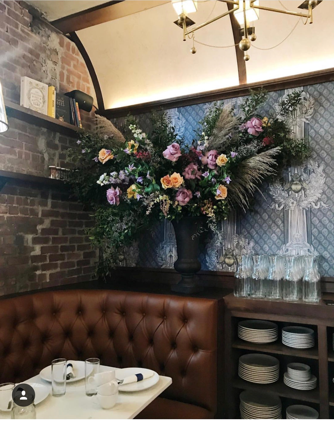 A floral pedestal arrangement by SPROUT HOME in the Hive restaurant in Brooklyn. Photo by Sprout Home.
