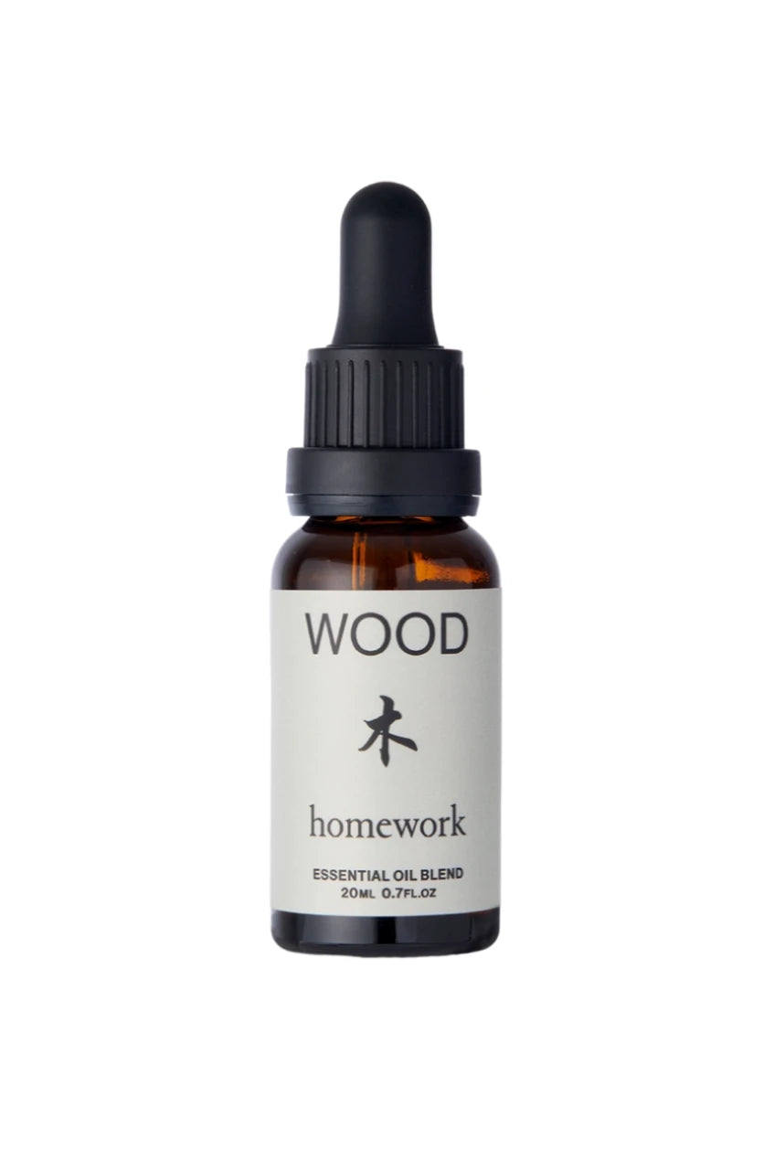 Wood essential Oil by Homework shown in its bottle
