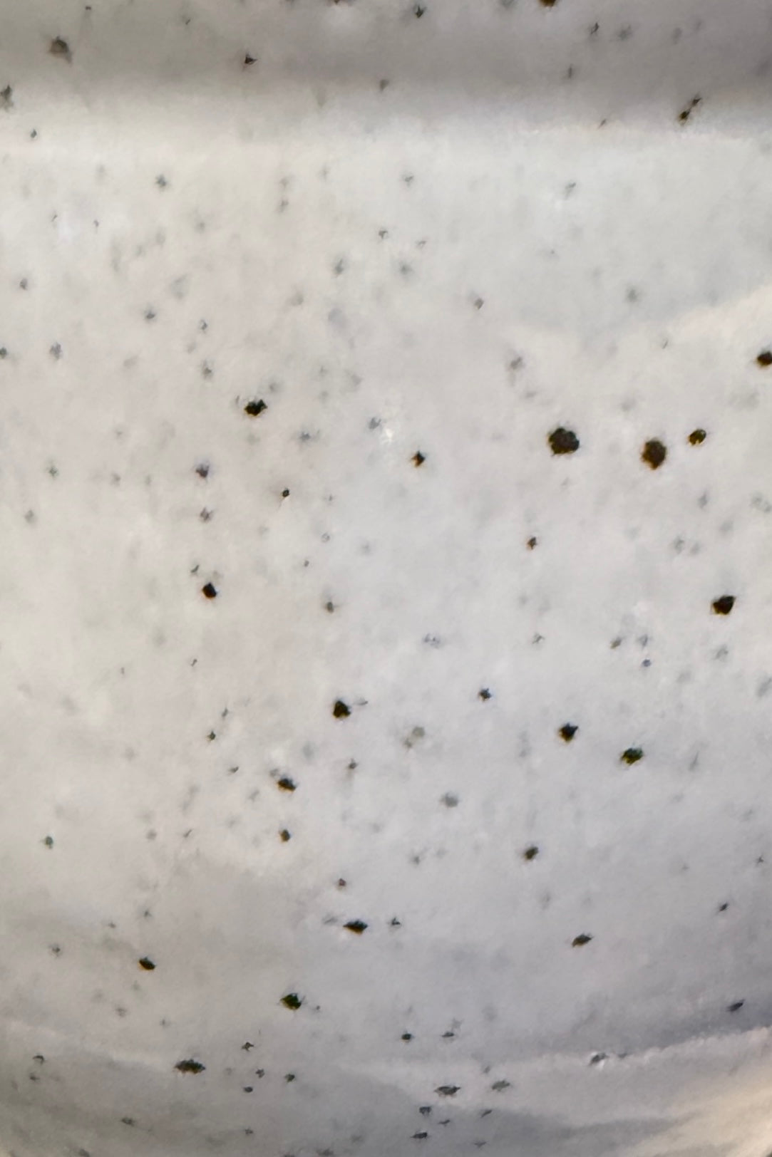 Close-up of a bright white with brown spots Glazed ceramic from Bruning Pottery ©Sprout Home