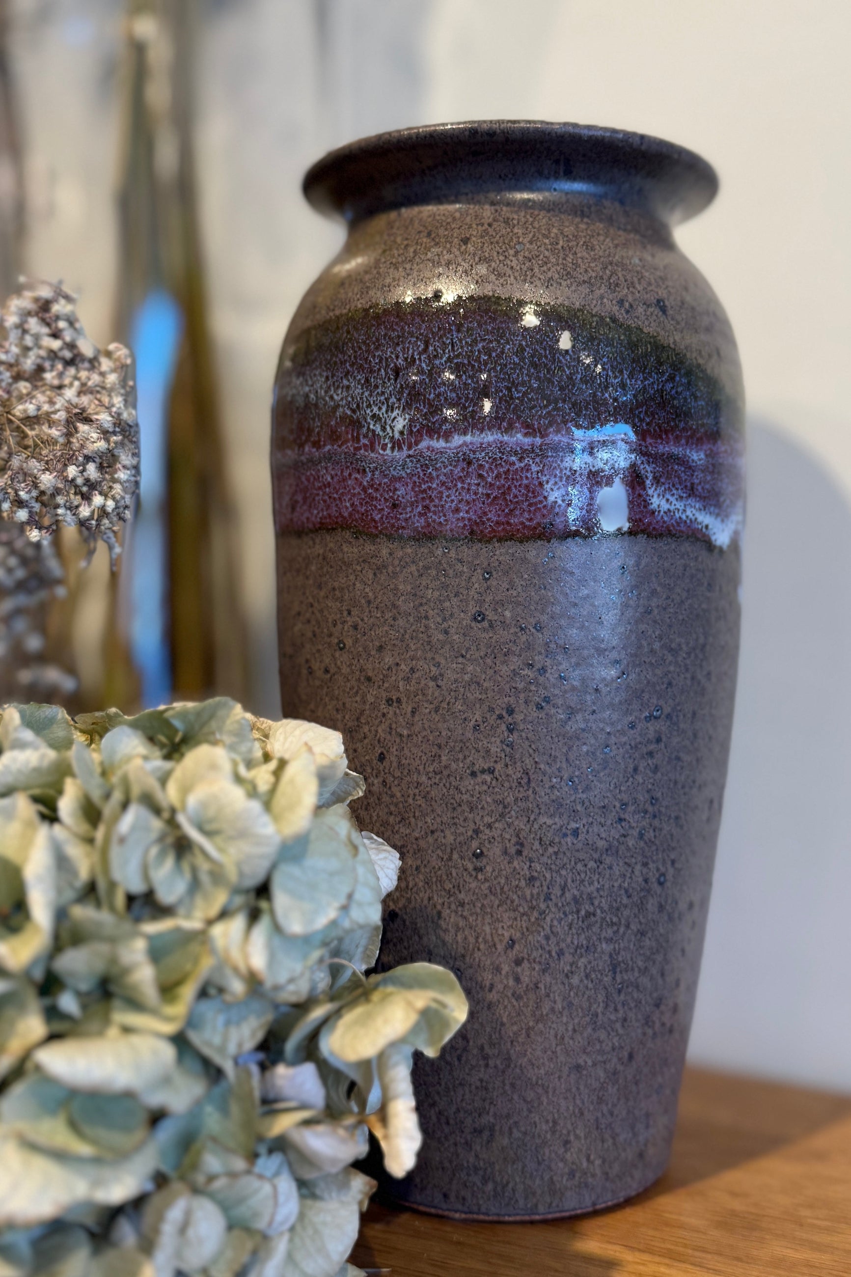Bruning Pottery handmade vase in a purple gray glaze on a shelf at Sprout Home Floral ©Sprout Home