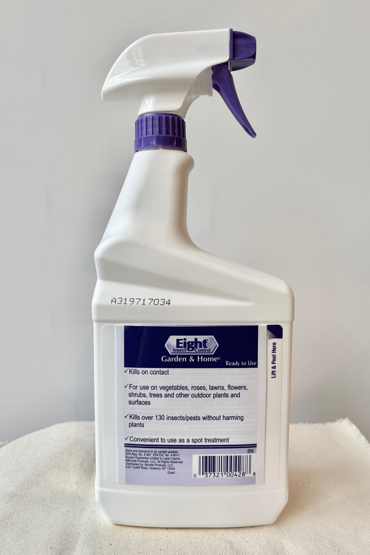 Back view of a 32oz Bottle of Bonide Eight insect control on a white surface against a white wall.