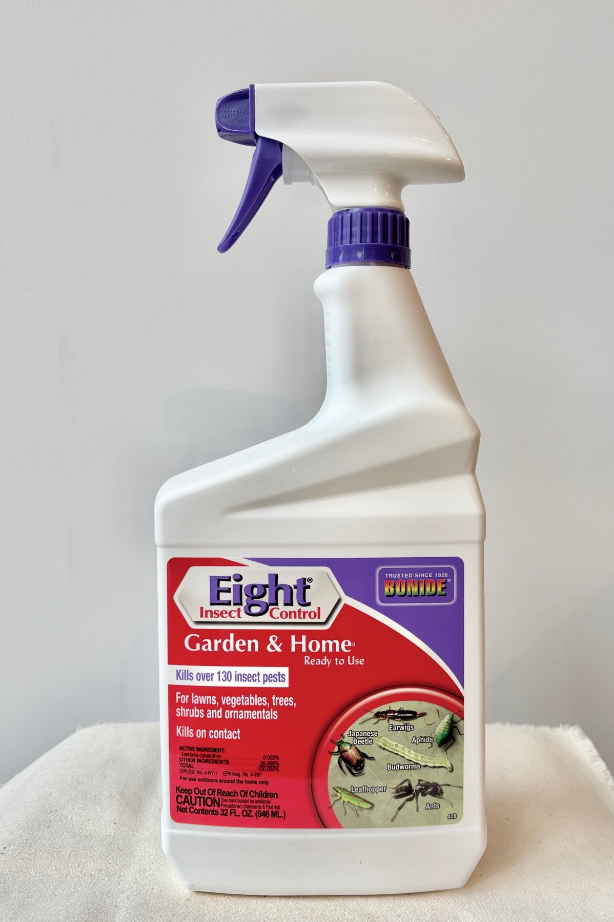 Front view of a 32oz Bottle of Bonide Eight insect control on a white surface against a white wall.