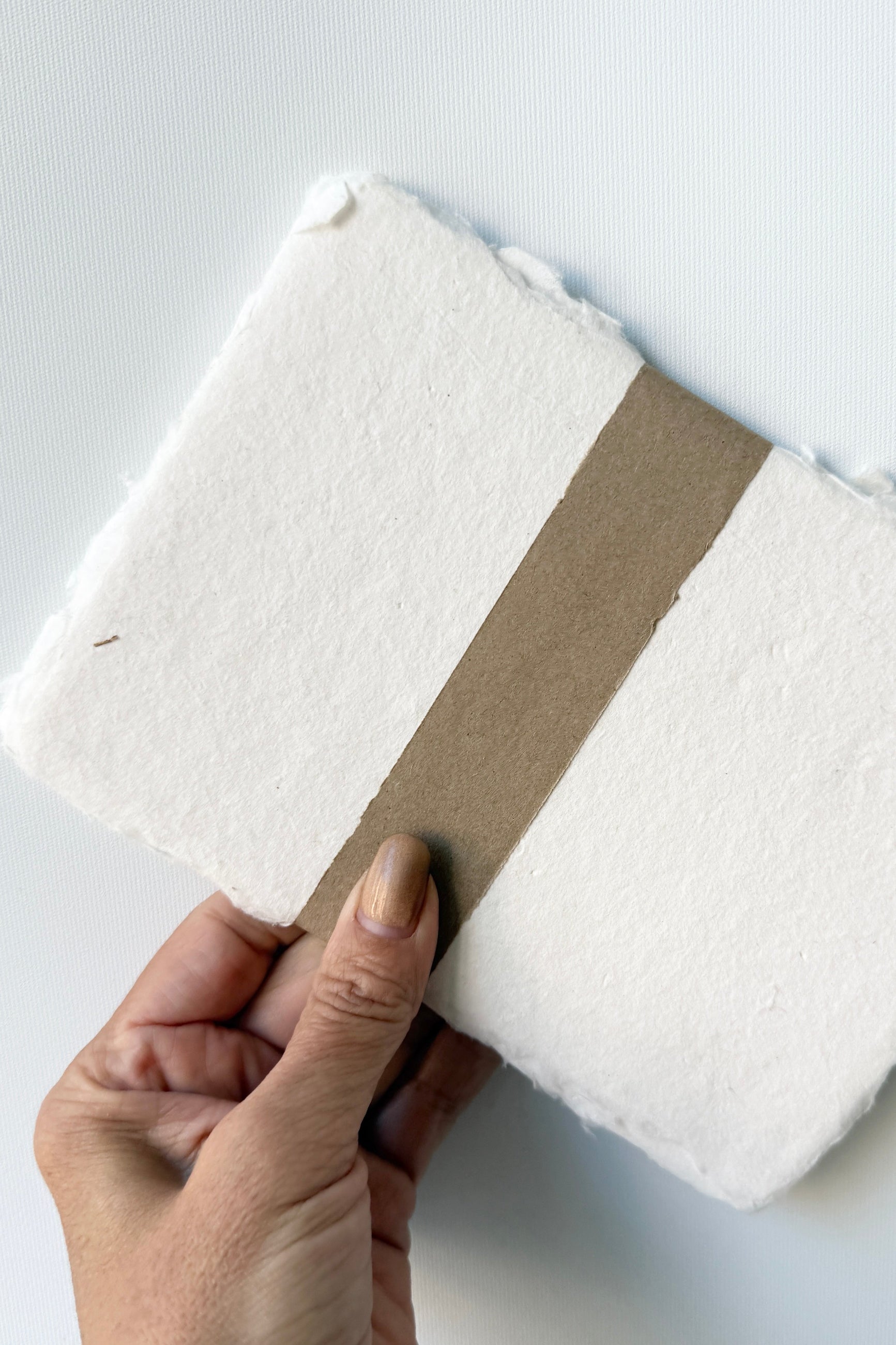 Handmade Natural White Paper Sheet Set in 5 x 7" handmade by Sustainable Paper & Craft being held against a white background ©Sprout Home