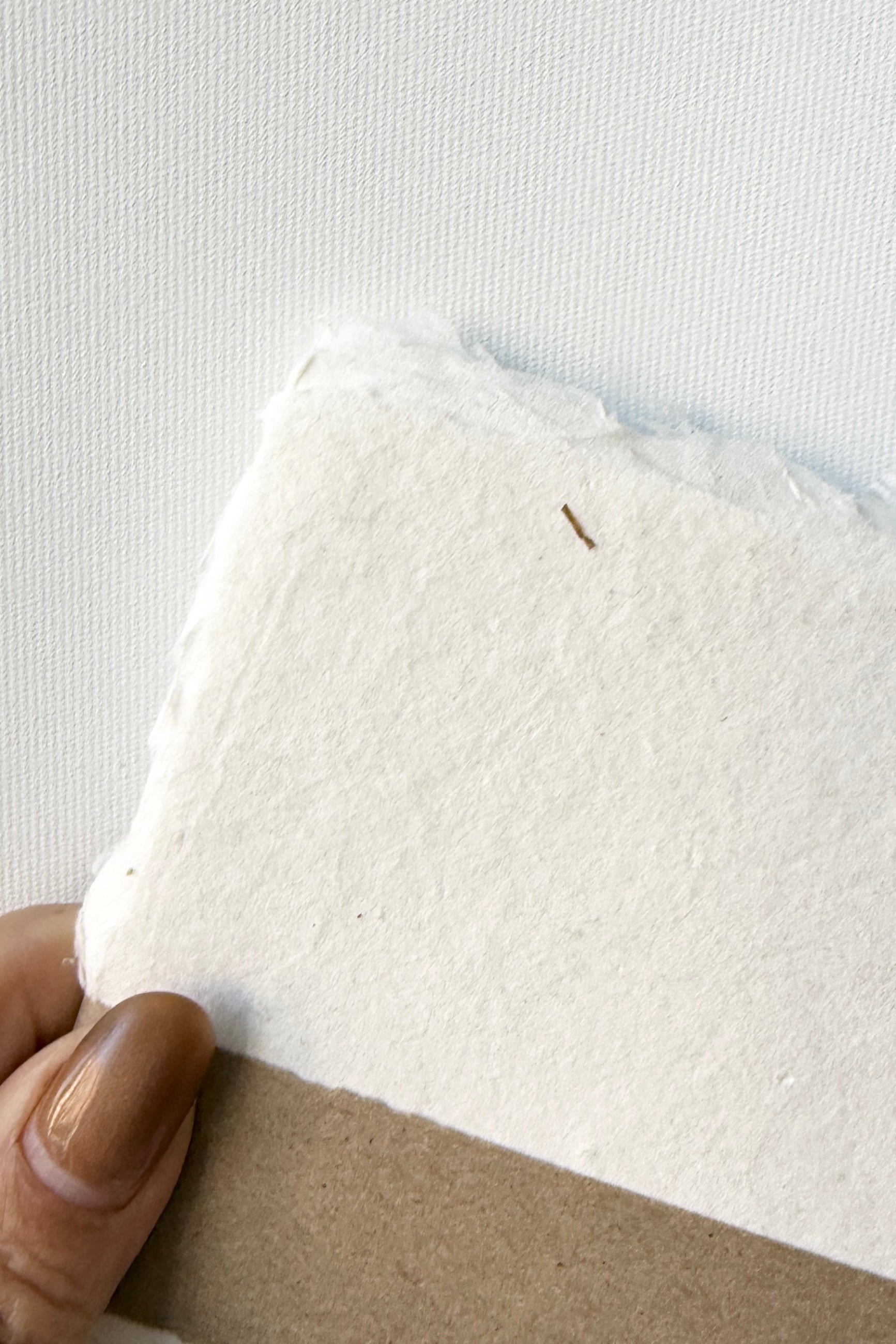 Handmade Natural White Paper Sheet Set in 5 x 7" handmade by Sustainable Paper & Craft being held against a white background ©Sprout Home