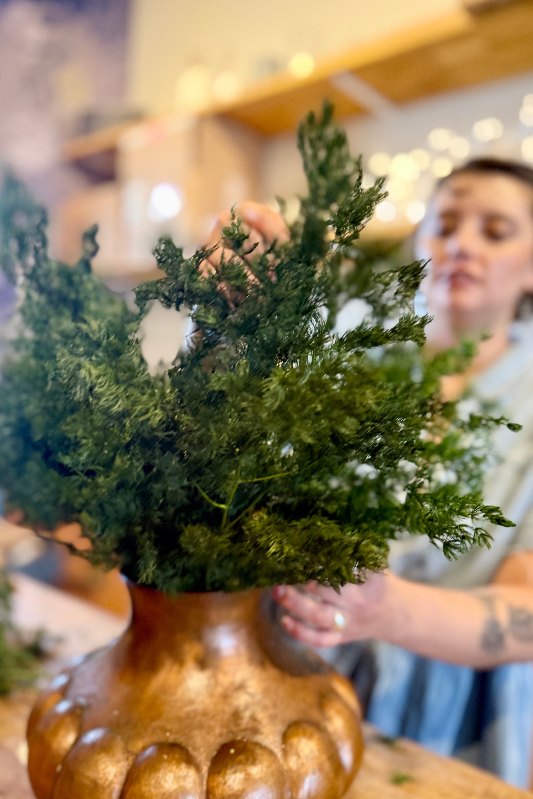 Asparagus Ming Natural Color Preserved Bunch being placed in a copper vase at Sprout Home Floral ©Sprout Home