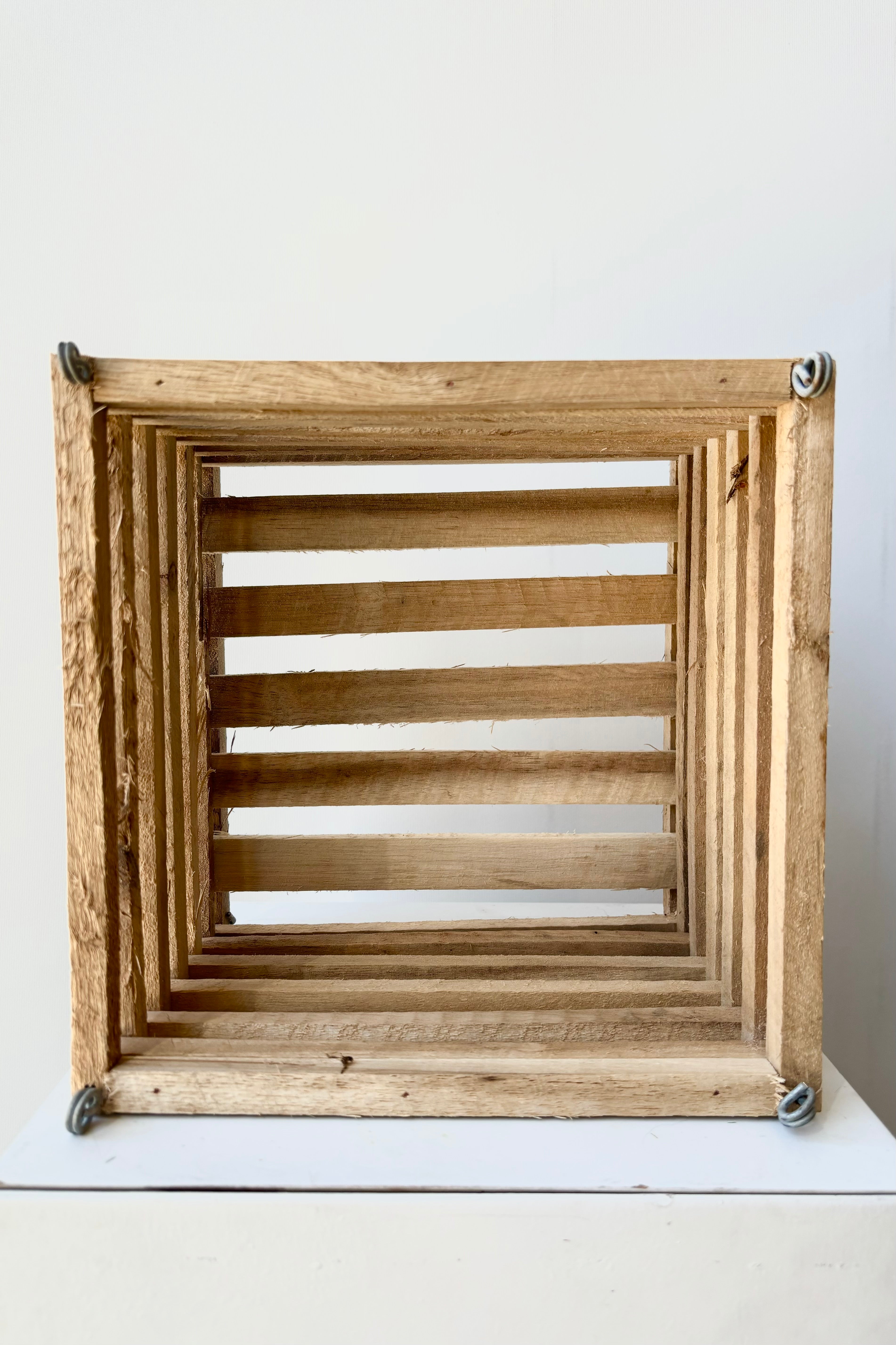 Wooden slatted vanda basket with metal rings for string attachment, not included, against white background