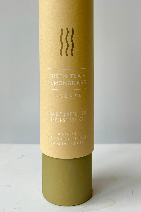 Detail of cardboard tube packaging with the words Green tea and lemongrass incense, mosquito repellent incense sticks, eight sticks, four and a half hour burn time, made in the USA
