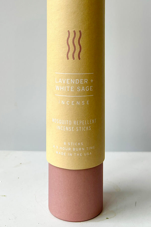 Detail of cardboard tube packaging with the words lavender and white sage incense, mosquito repellent incense sticks, eight sticks, four and a half hour burn time, made in the USA