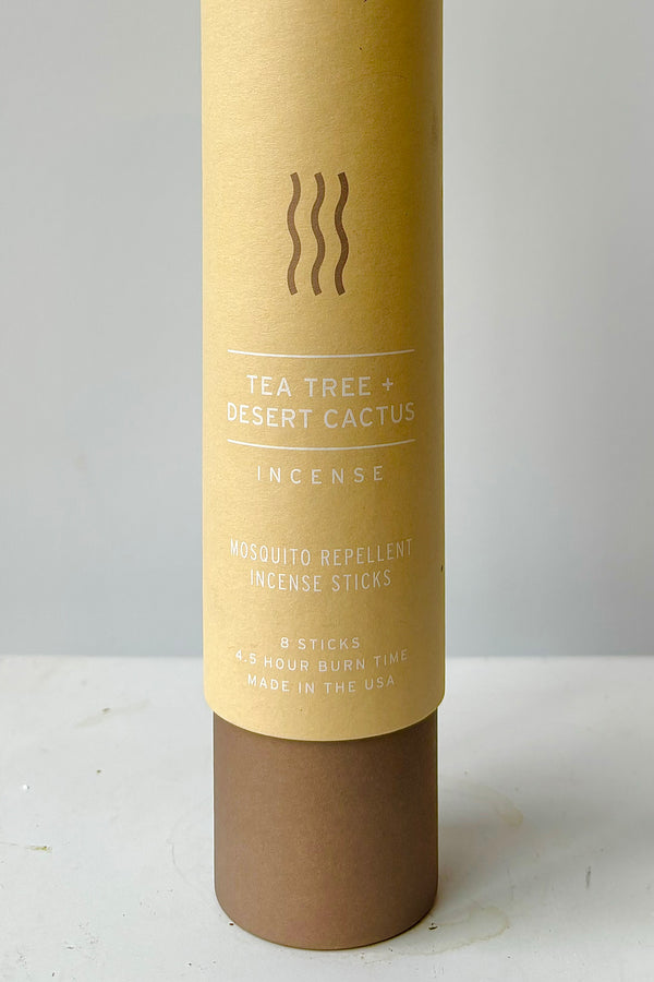 Detail of cardboard tube packaging with the words tea tree and desert cactus incense, mosquito repellent incense sticks, eight sticks, four and a half hour burn time, made in the USA