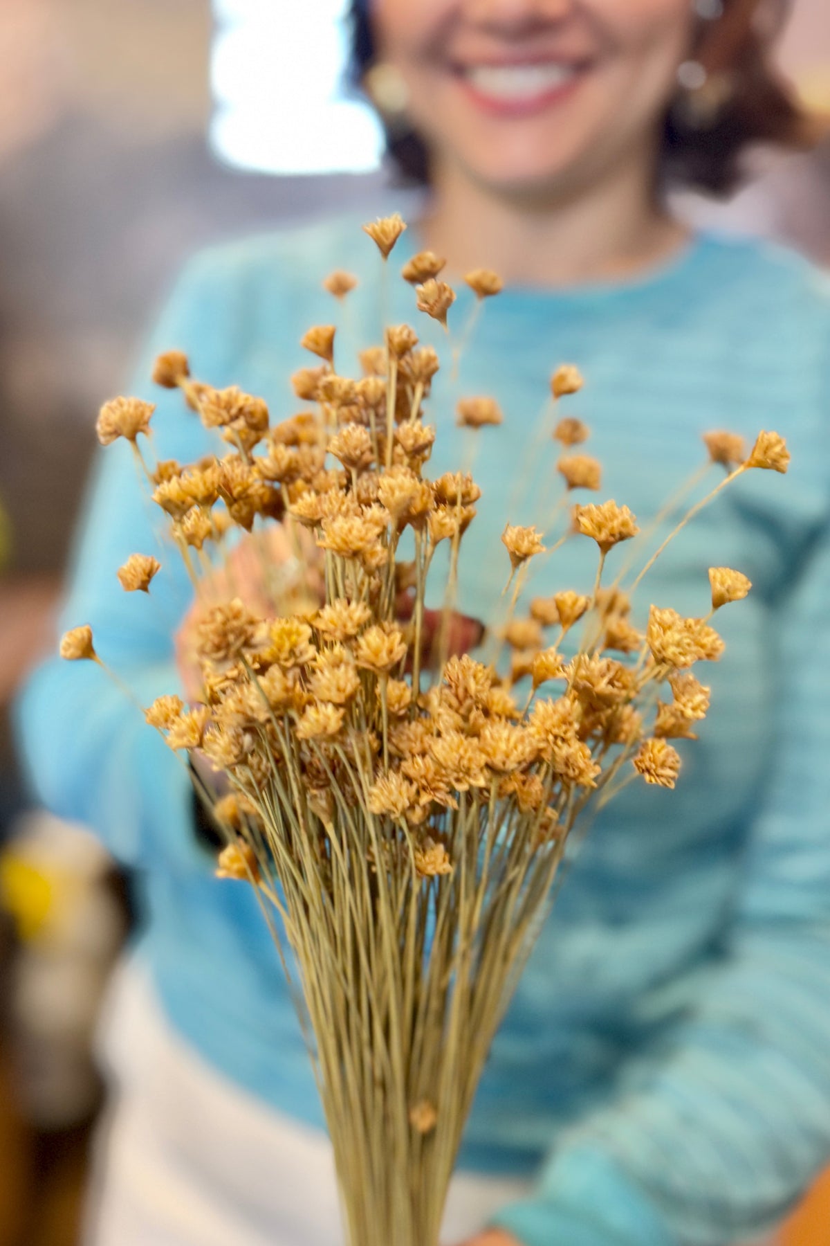 person in a blue shirt holding Hill Flower Natural Color Preserved Bunch ©Sprout Home