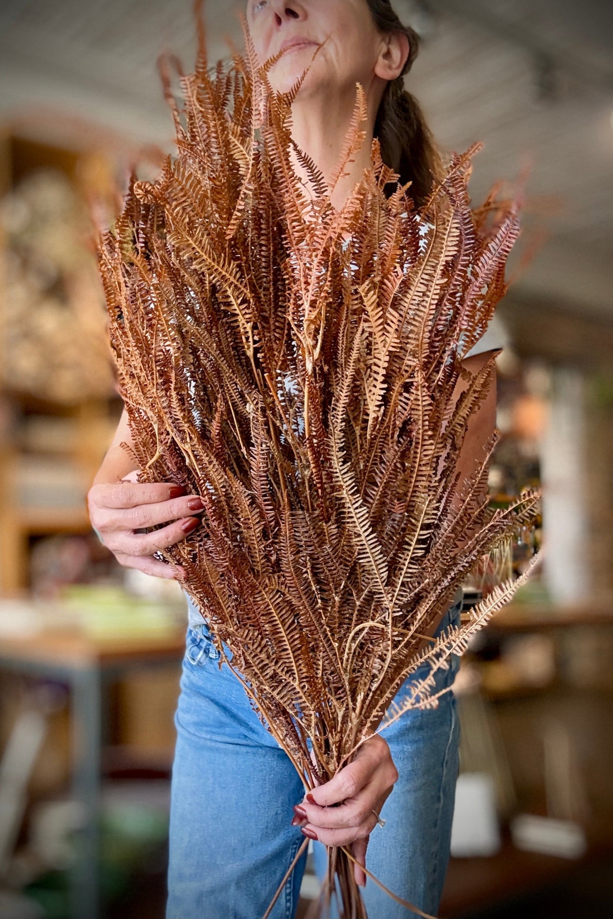 person holding a Helecho x3 Natural Preserved Bunch with a blurred background ©Sprout Home