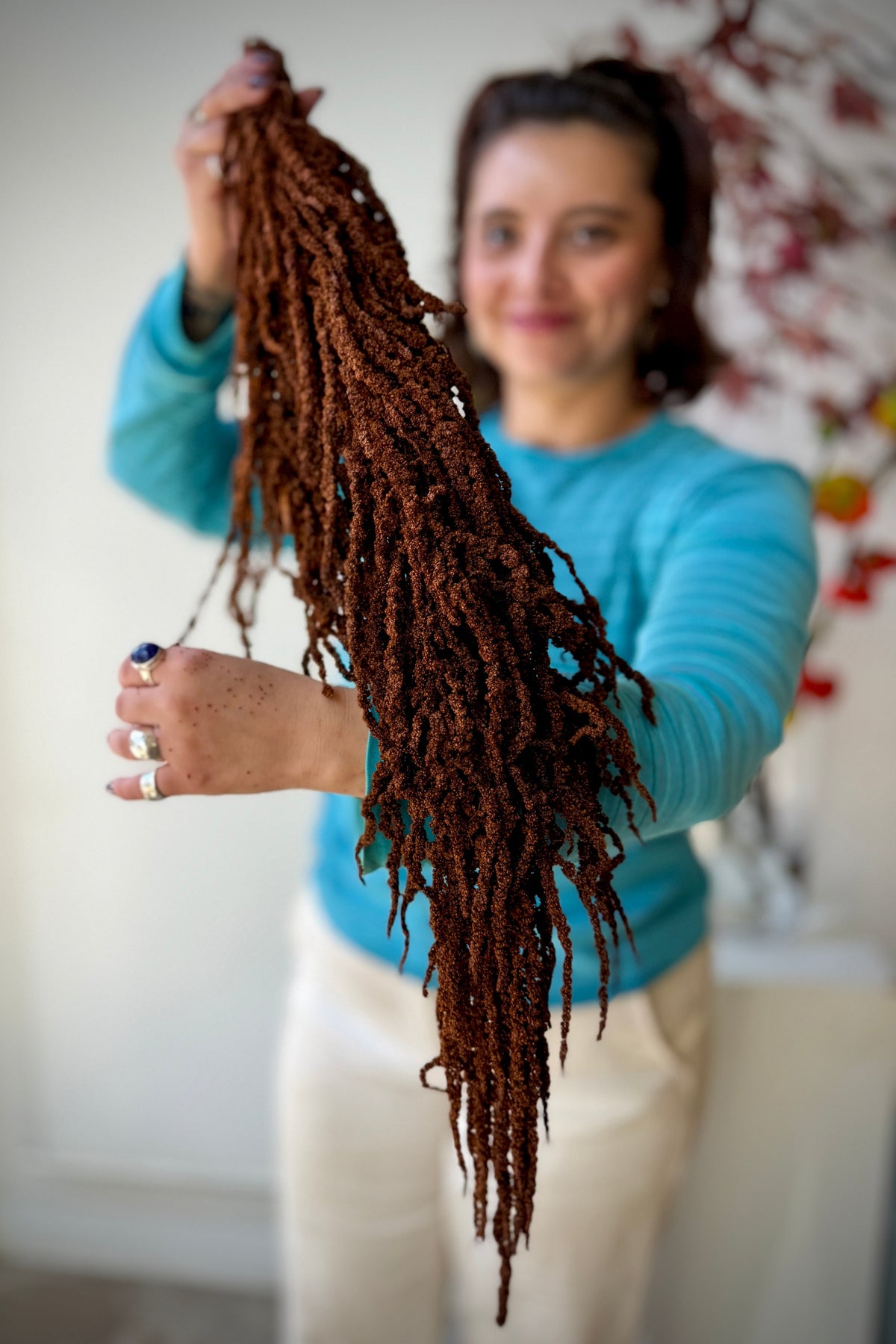 Amaranthus Mocha Color Preserved Bunch being held by a Sprout Home associate showing it off ©Sprout Home
