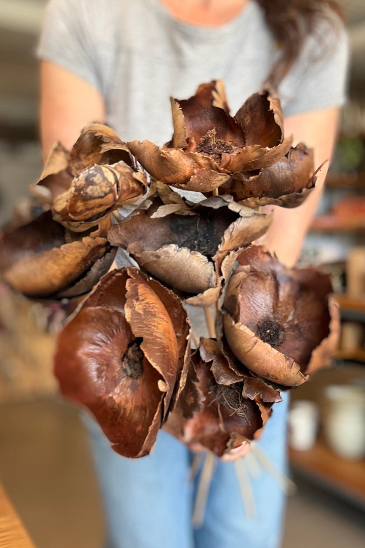 Palm Cap Natural Color Preserved Bunch being shown to the camera in hand ©Sprout Home