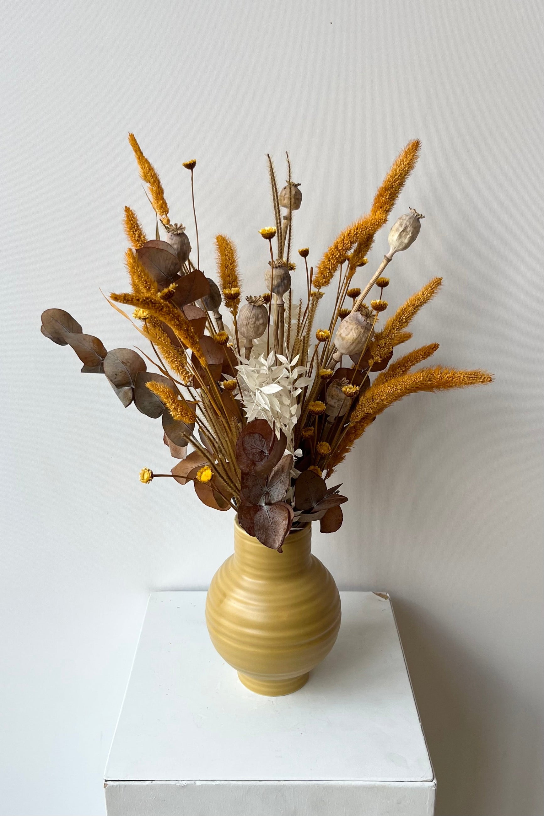 Different types of dried floral with the colors yellow, white and tan in a yellow vase created by Sprout Home ©Sprout Home #size_$60
