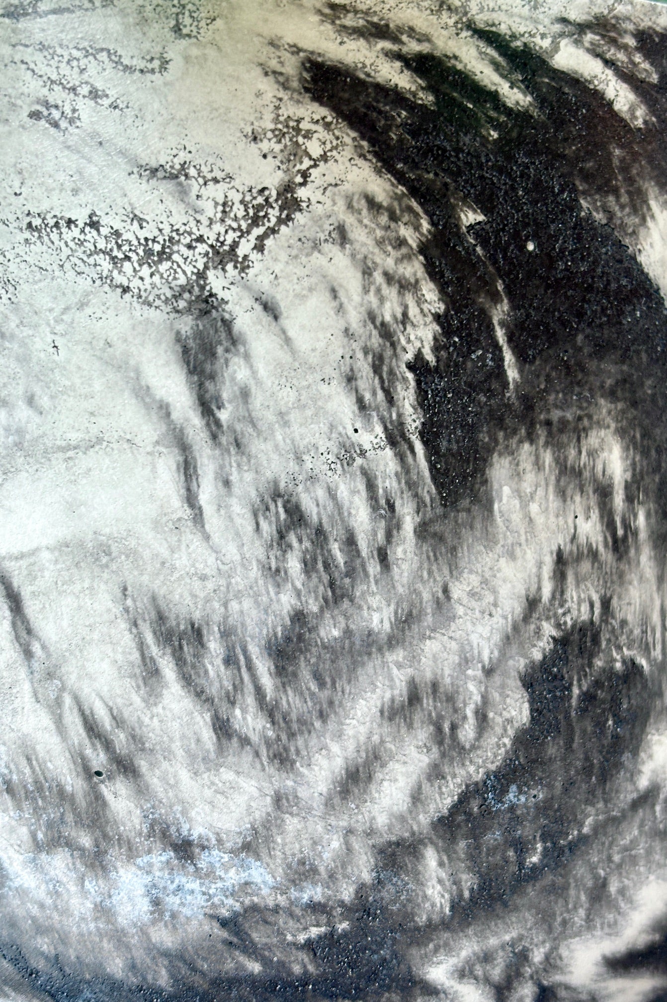 Close up of Marbled black and white varnished cement planter with drain hole and saucer