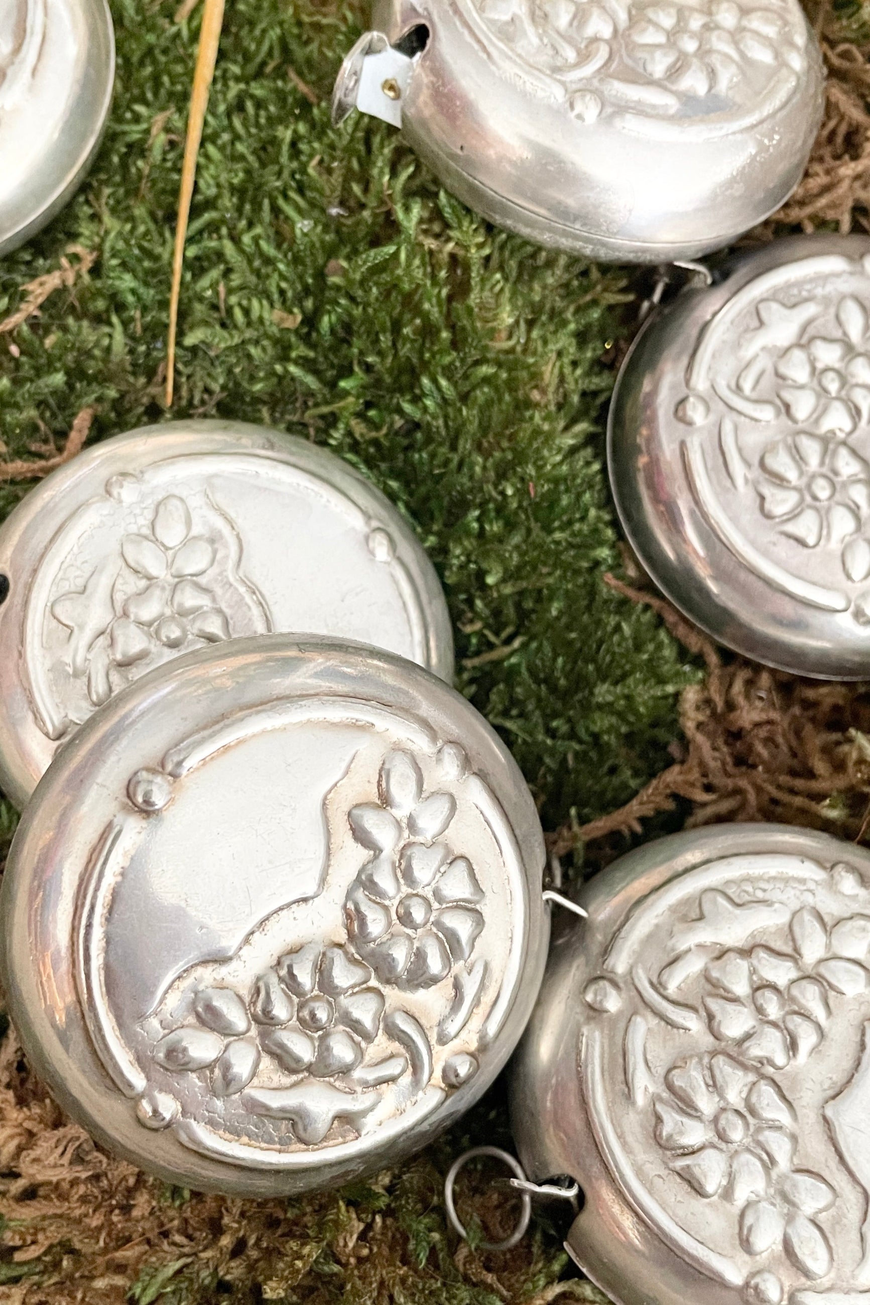 Flower measuring tapes on a bed of dried moss at Sprout Home. ©Sprout Home