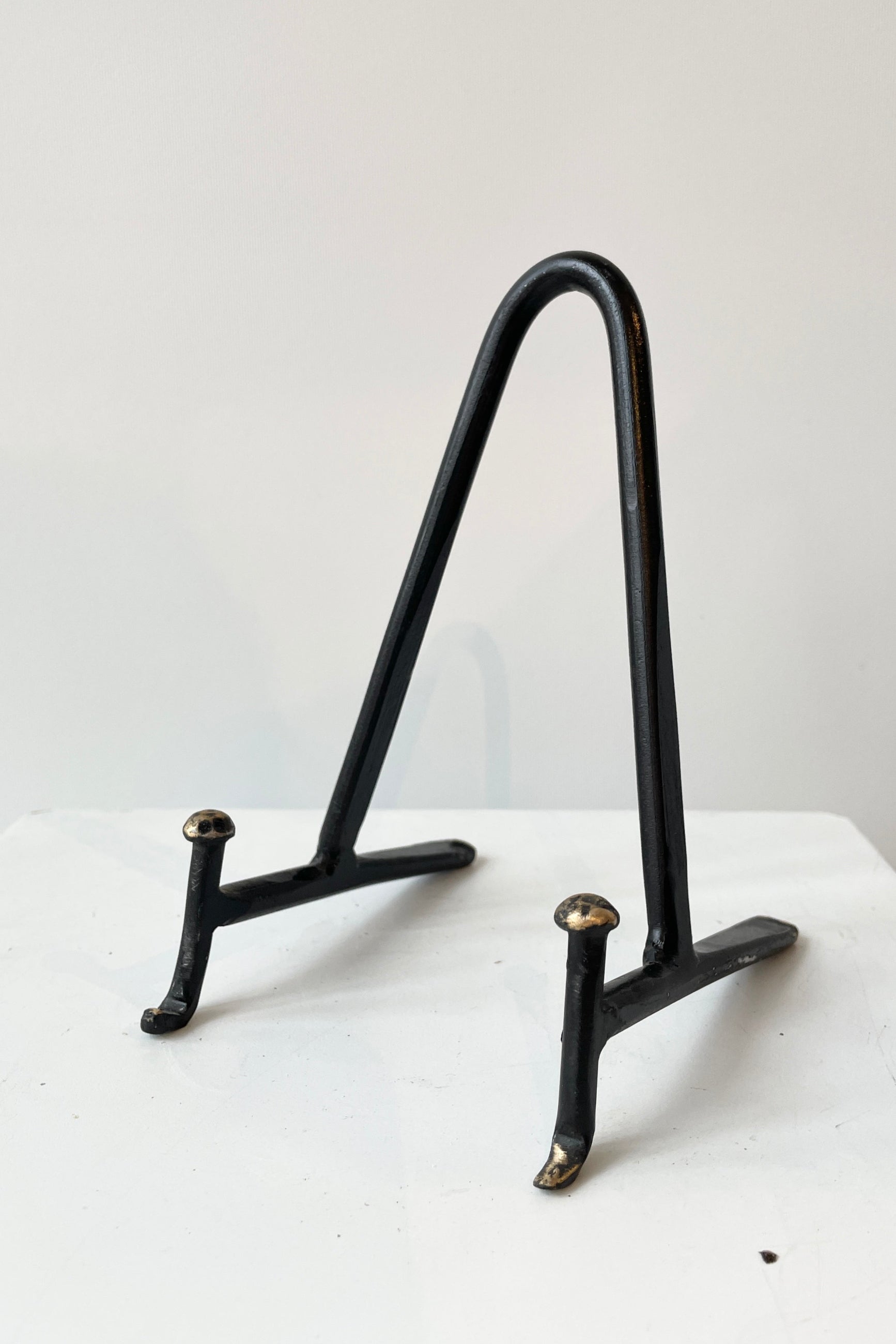The Small Cast Iron display stand in small viewed at eye level from the front side. ©Sprout Home