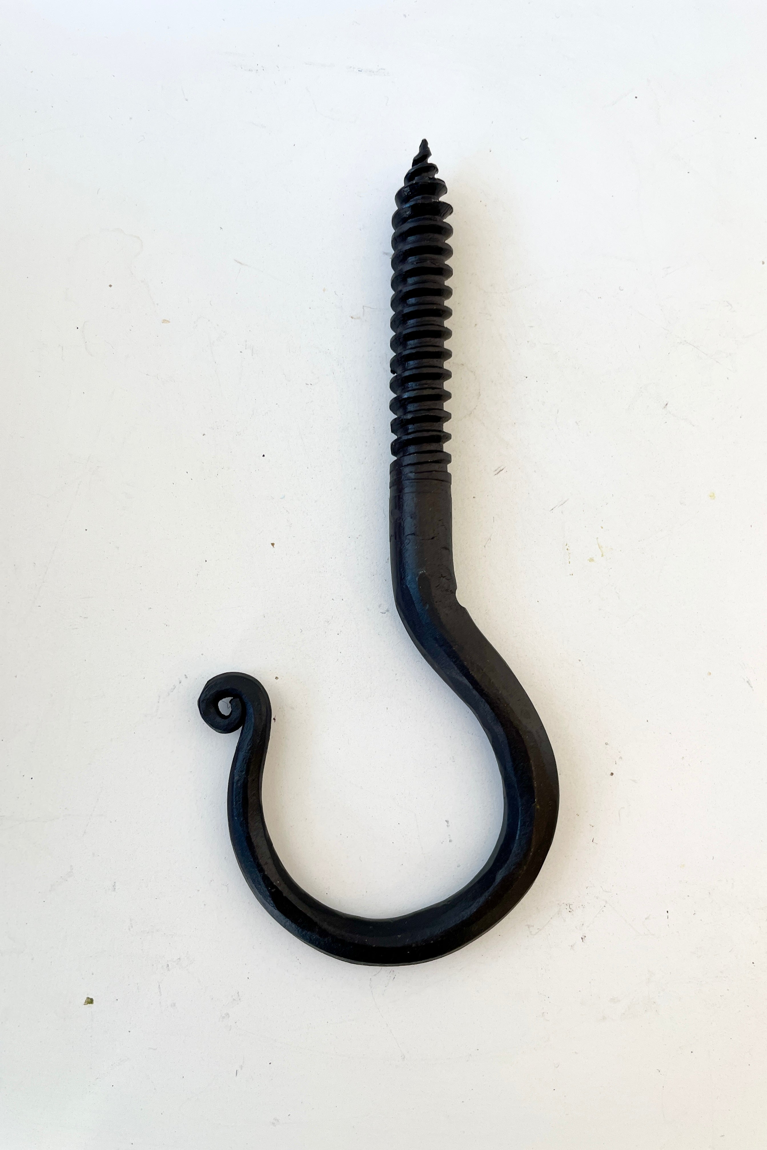 A threaded blacksmiths hook at Sprout Home being shown from the side.
