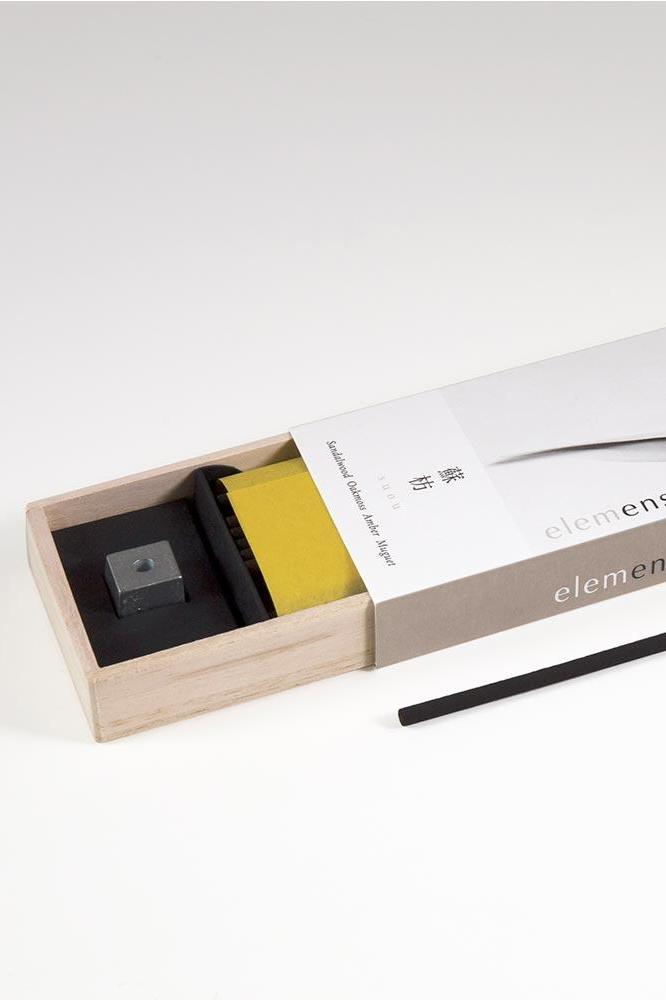 Elemense Suou Incense shown with the packaging slightly open on the bottom revealing the holder.