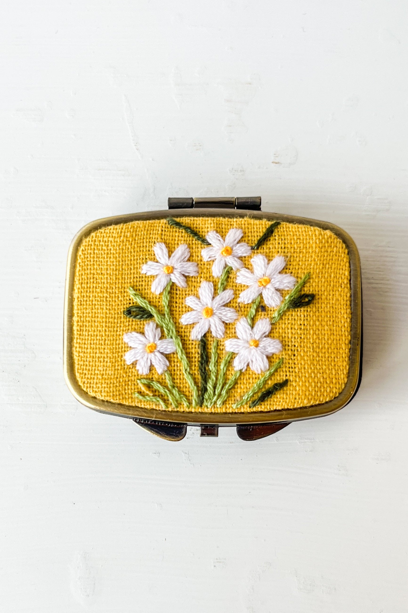 Small rectangular box with floral embroidery on a white background ©Sprout Home