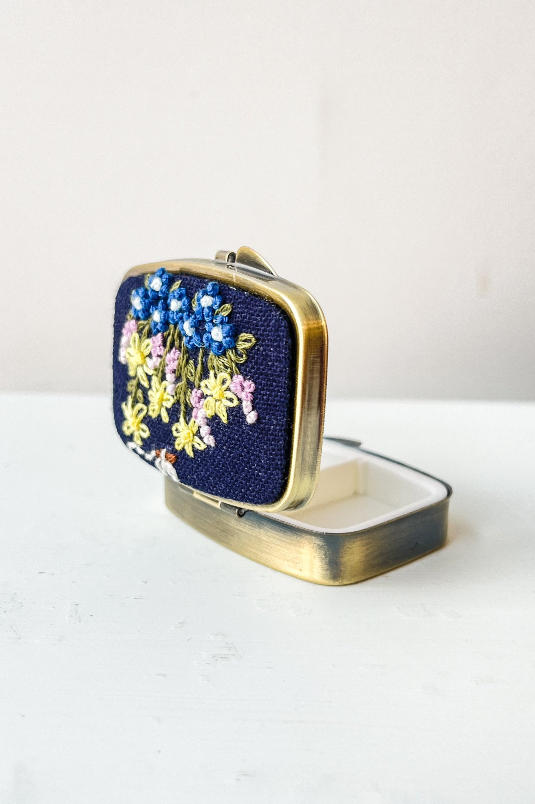 Compact trinket box with floral design on a white background ©Sprout Home