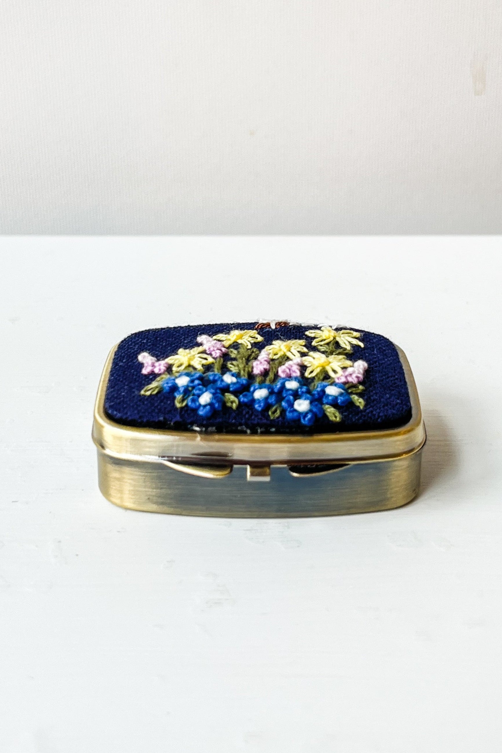 Decorative pill box with floral design on a white surface ©Sprout Home