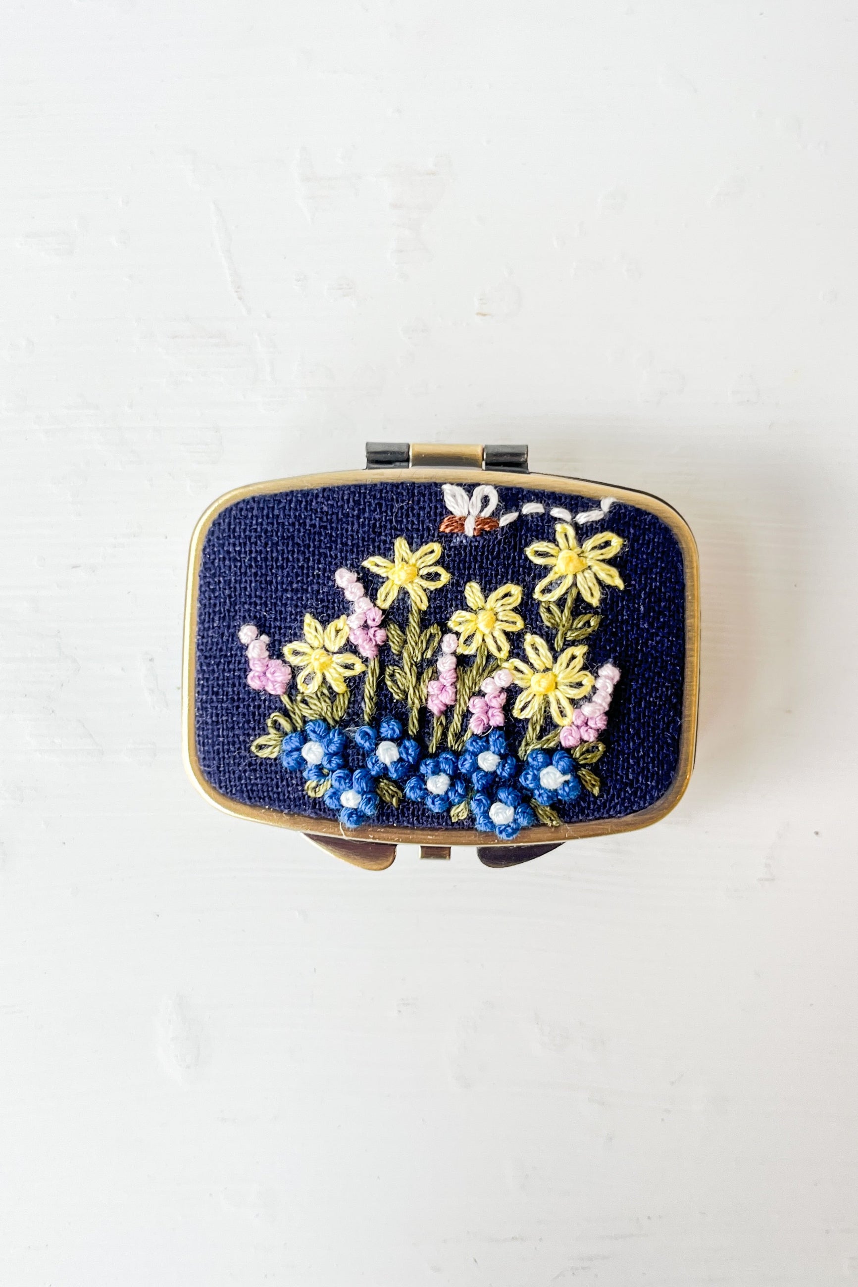 Small rectangular box with floral embroidery on a white background ©Sprout Home