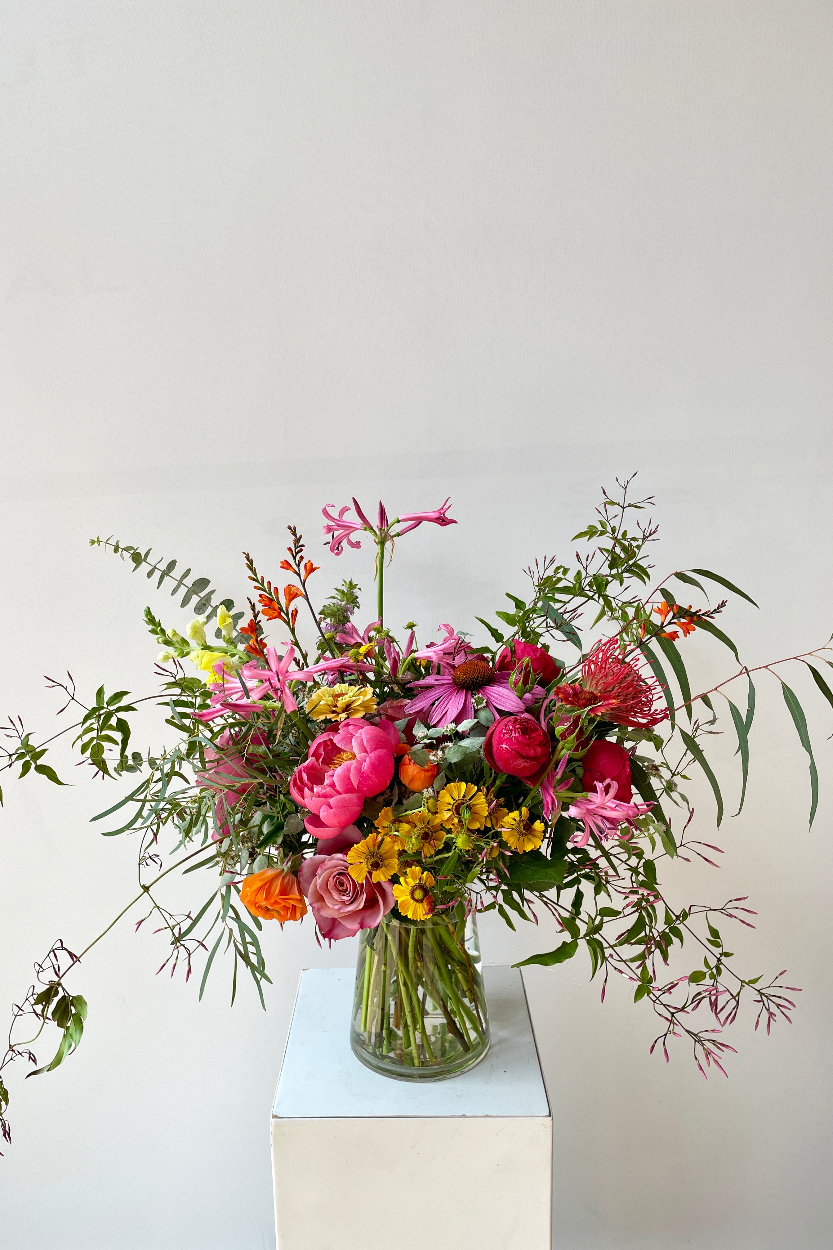 A bright and fun Mid Day custom arrangement in July featuring jasmin vine #size_$200