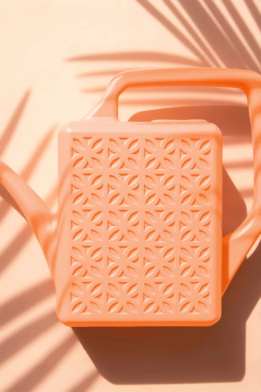 Peach Breeze Block watering can on a pink background by Jungle Club