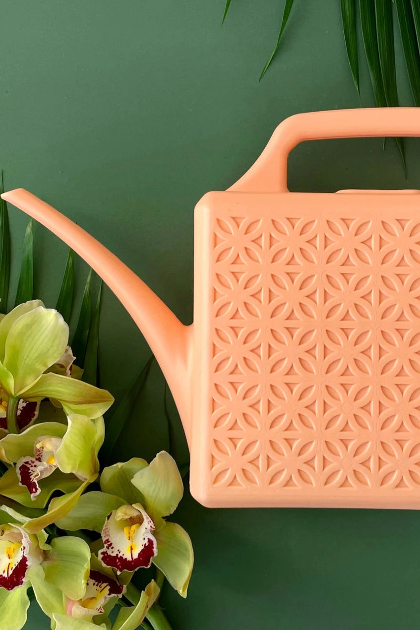 Peach Breeze Block watering can on green with orchids by Jungle Club