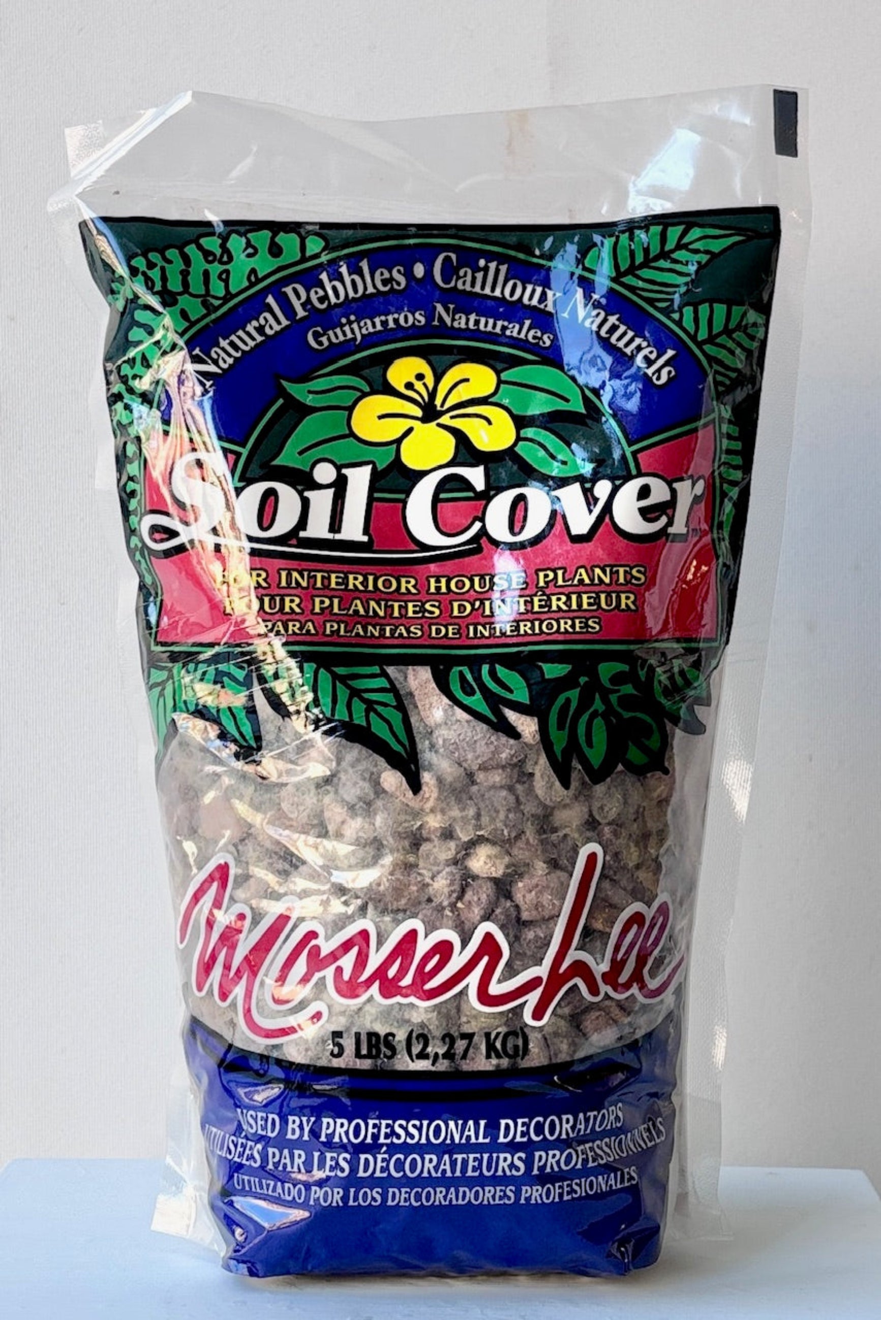 Bag of large natural color pebbles for topping on soil or terrariums against a white wall ©Sprout Home