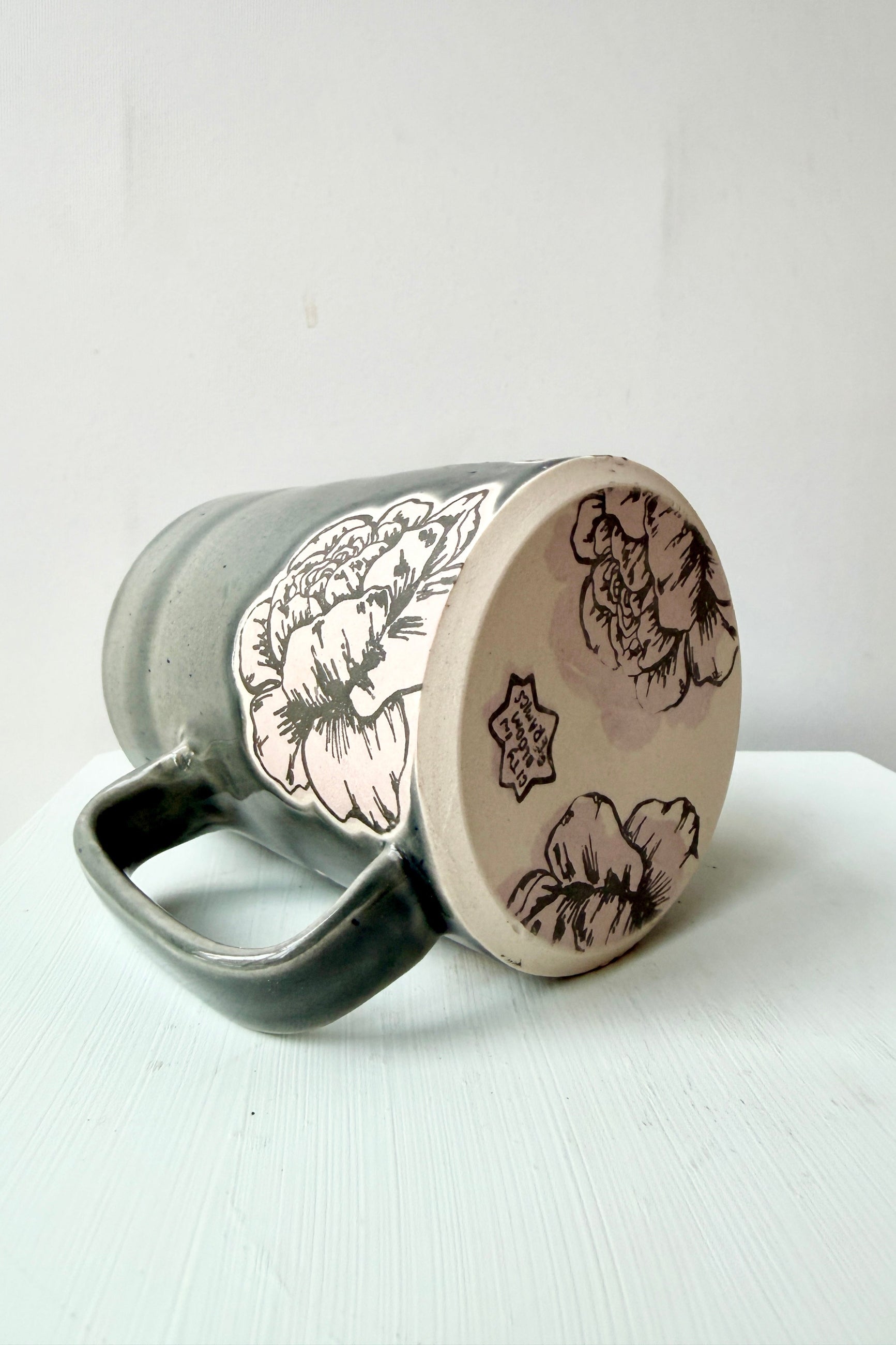 Ceramic Peoy mug with floral patterns on side and bottom by City in Bloom Ceramics a white background ©Sprout Home