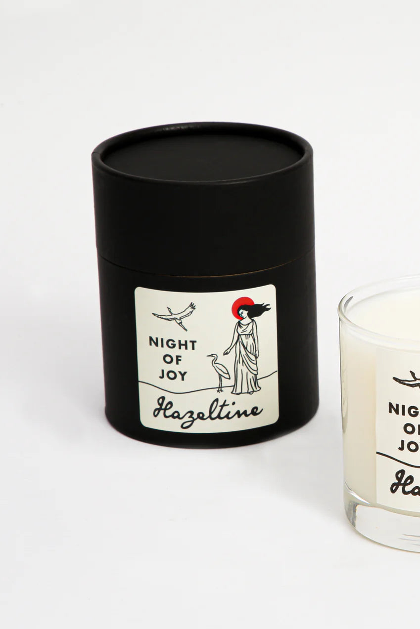 Candle abeled 'Night of Joy' by Hazeltime with black lid on a white background ©Hazeltine