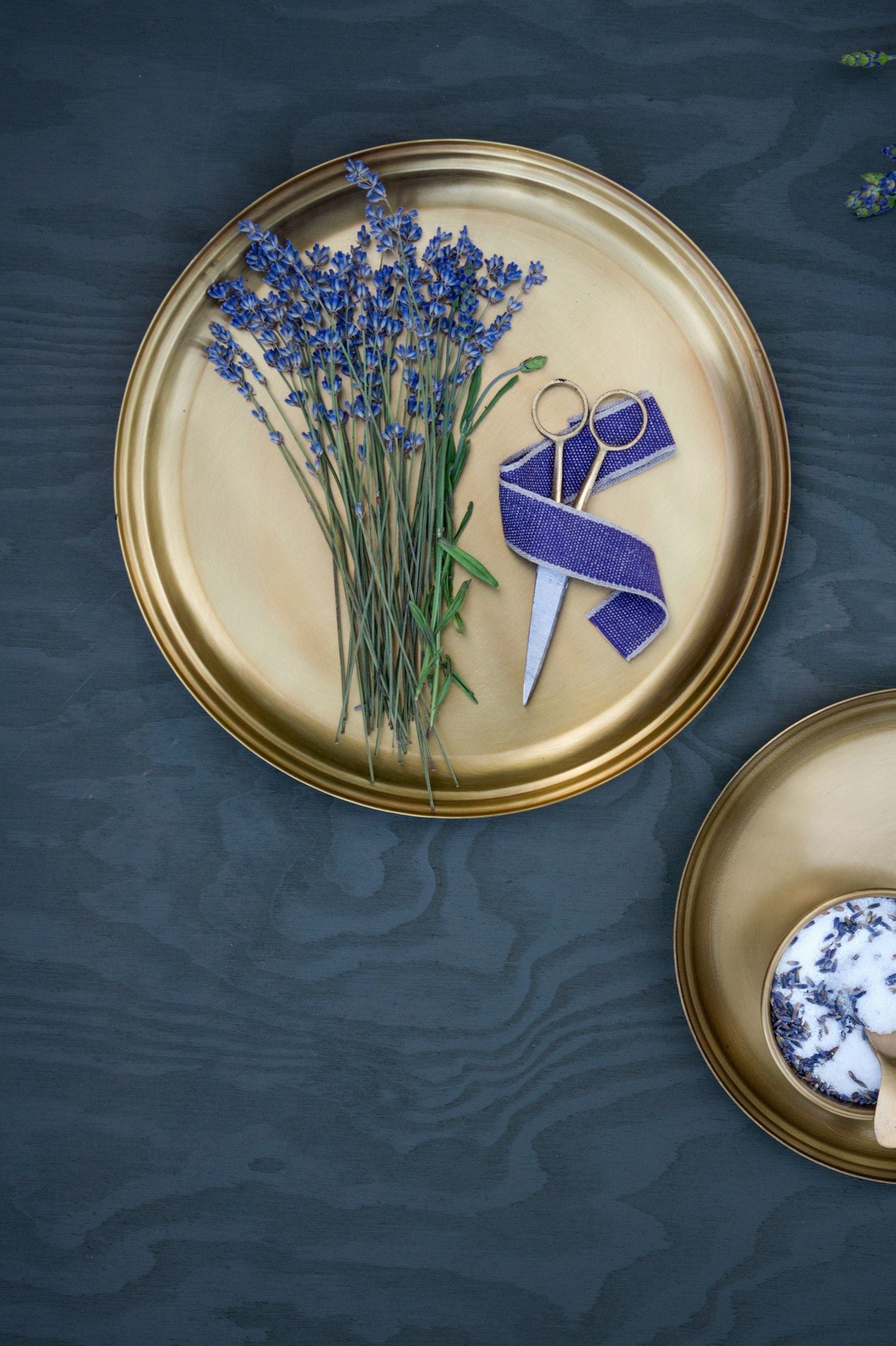 Brass plate by Fog Linen Work with lavender stems and a pair of scissors.