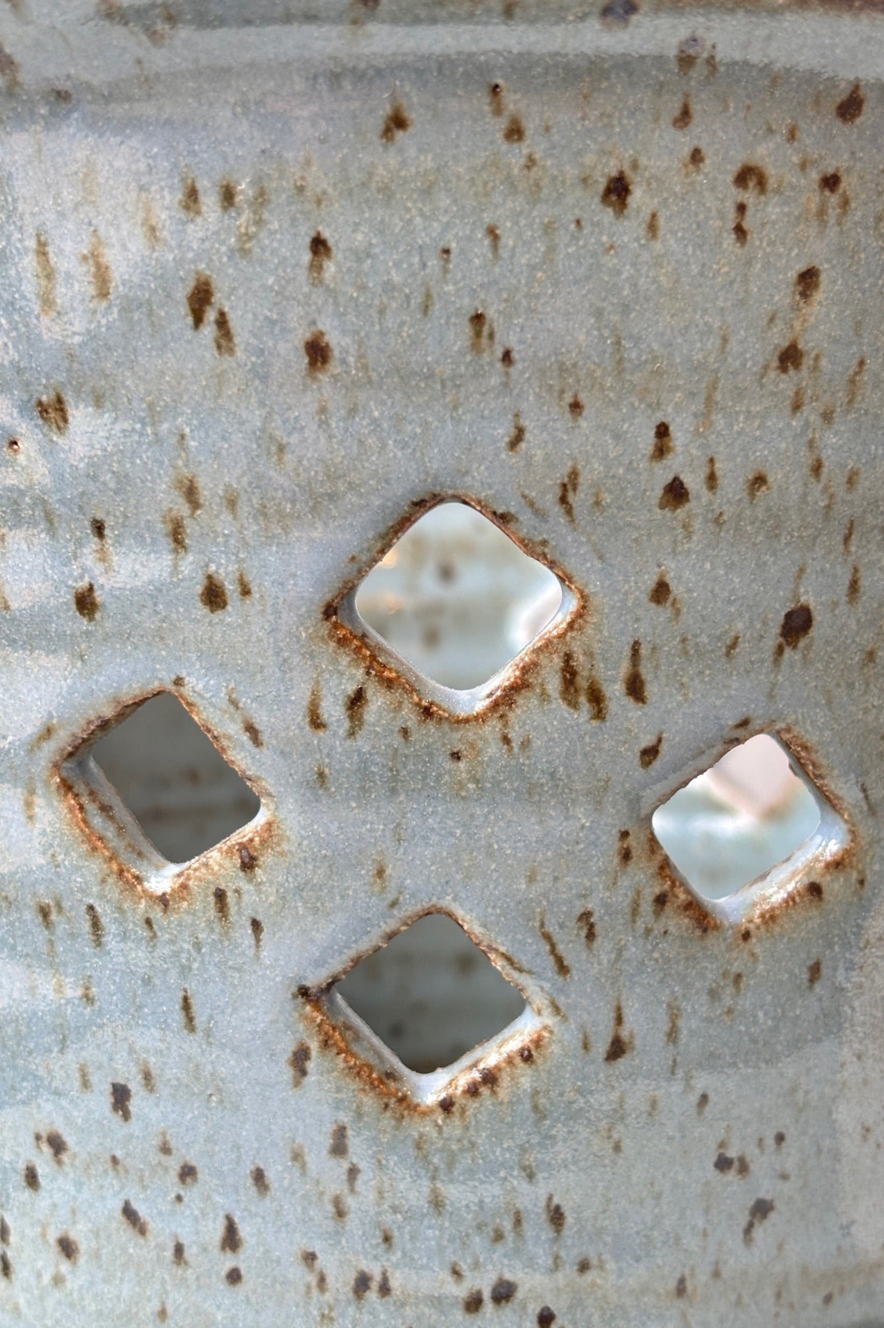 Close up of glaze and diamond pattern air holes on the side of the glazed conflower 7" orchid pot ©sprout home