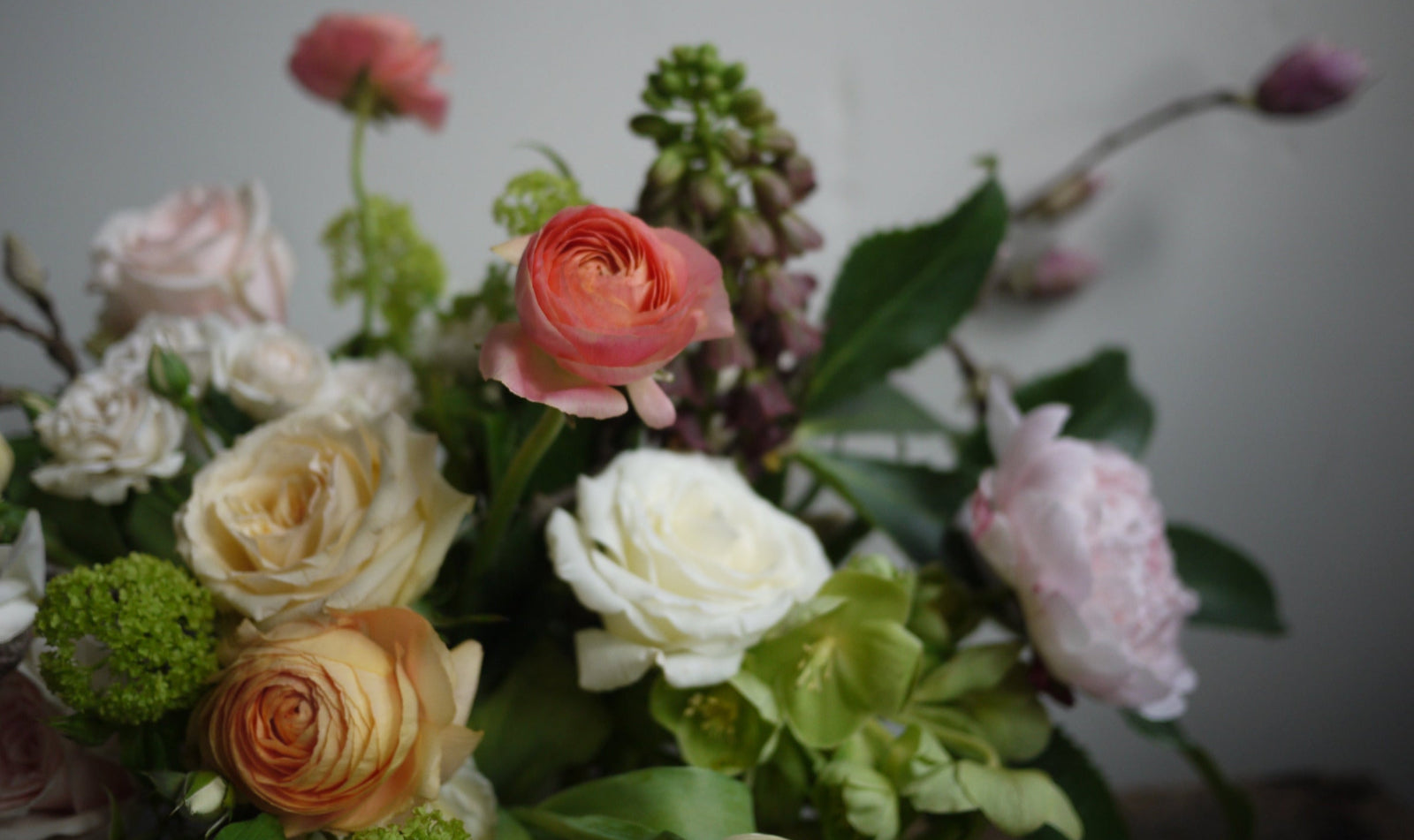 Floral arrangement up close by Sprout Home featuring ranunculus