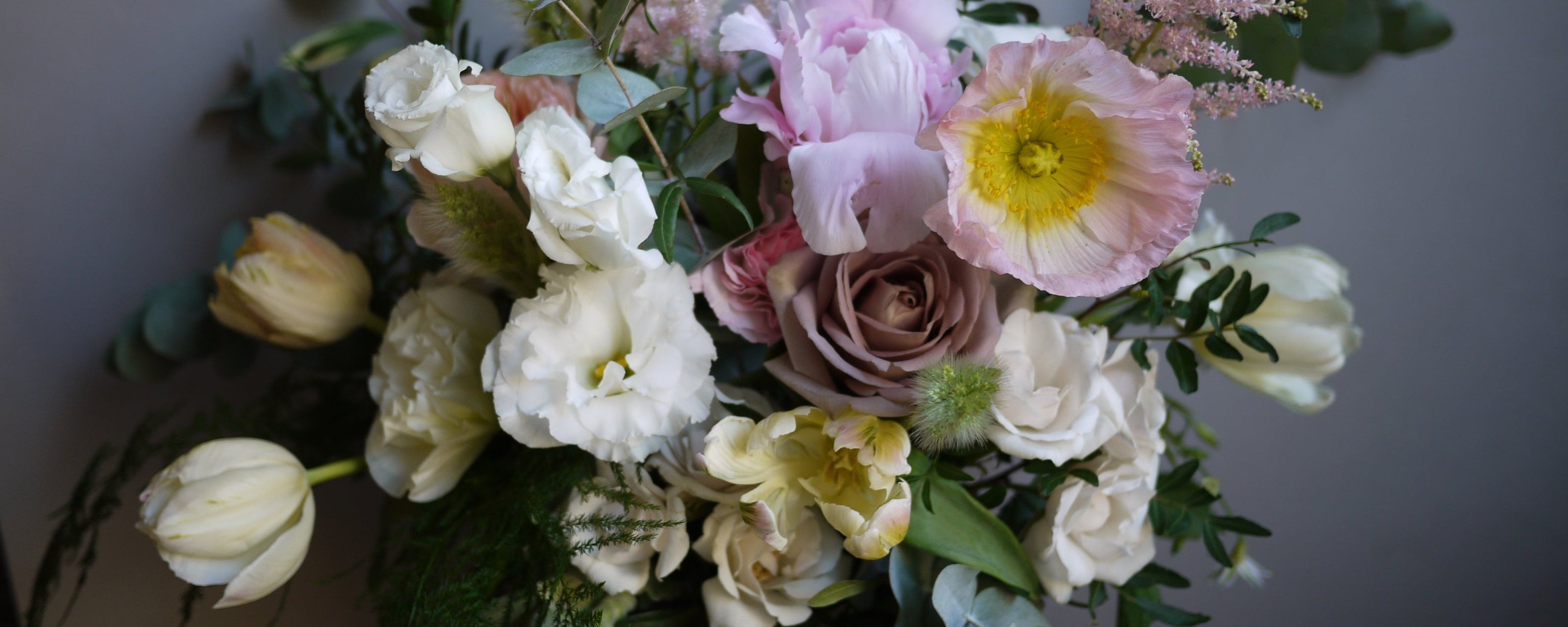 Bouquet of flowers with tulips and poppy and rose with pastel colors against a neutral background ©Sprout Home