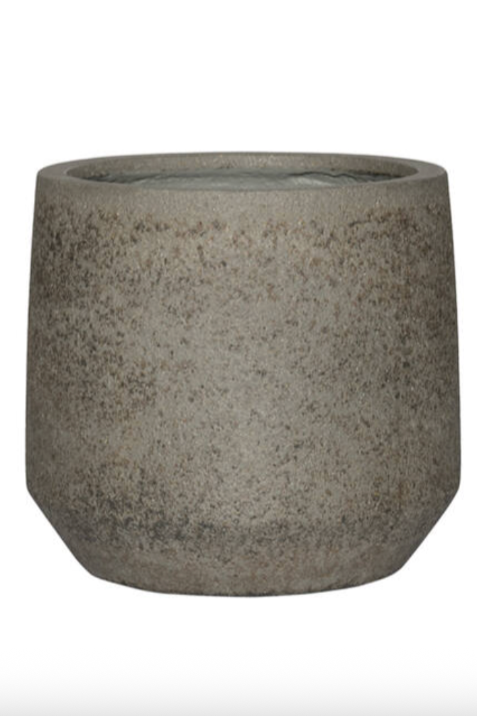 A textured gray pot with a tapered based in front of a white wall ©Sprout Home