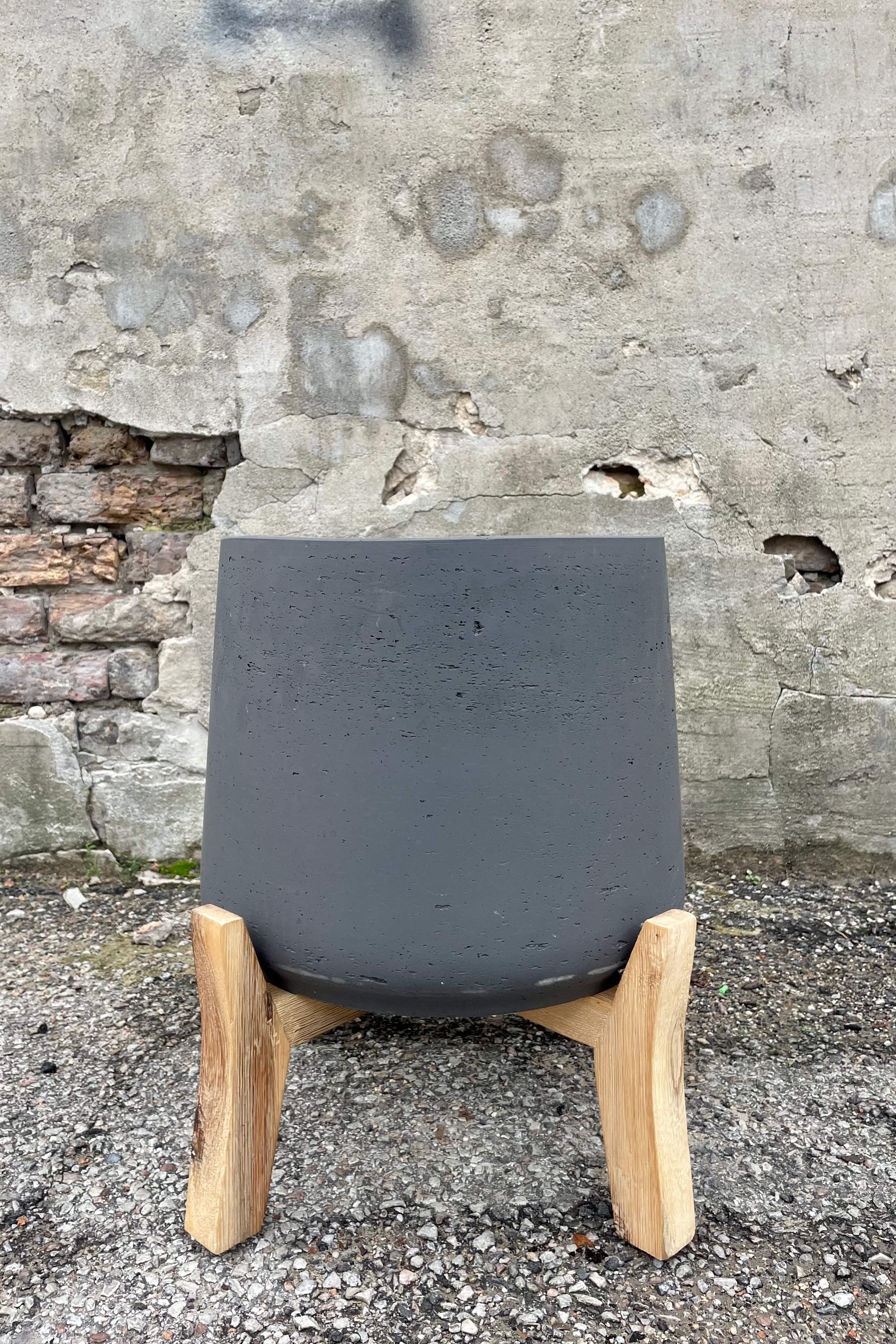 Photo of matte black textured planter Patt Pot with low feet stand