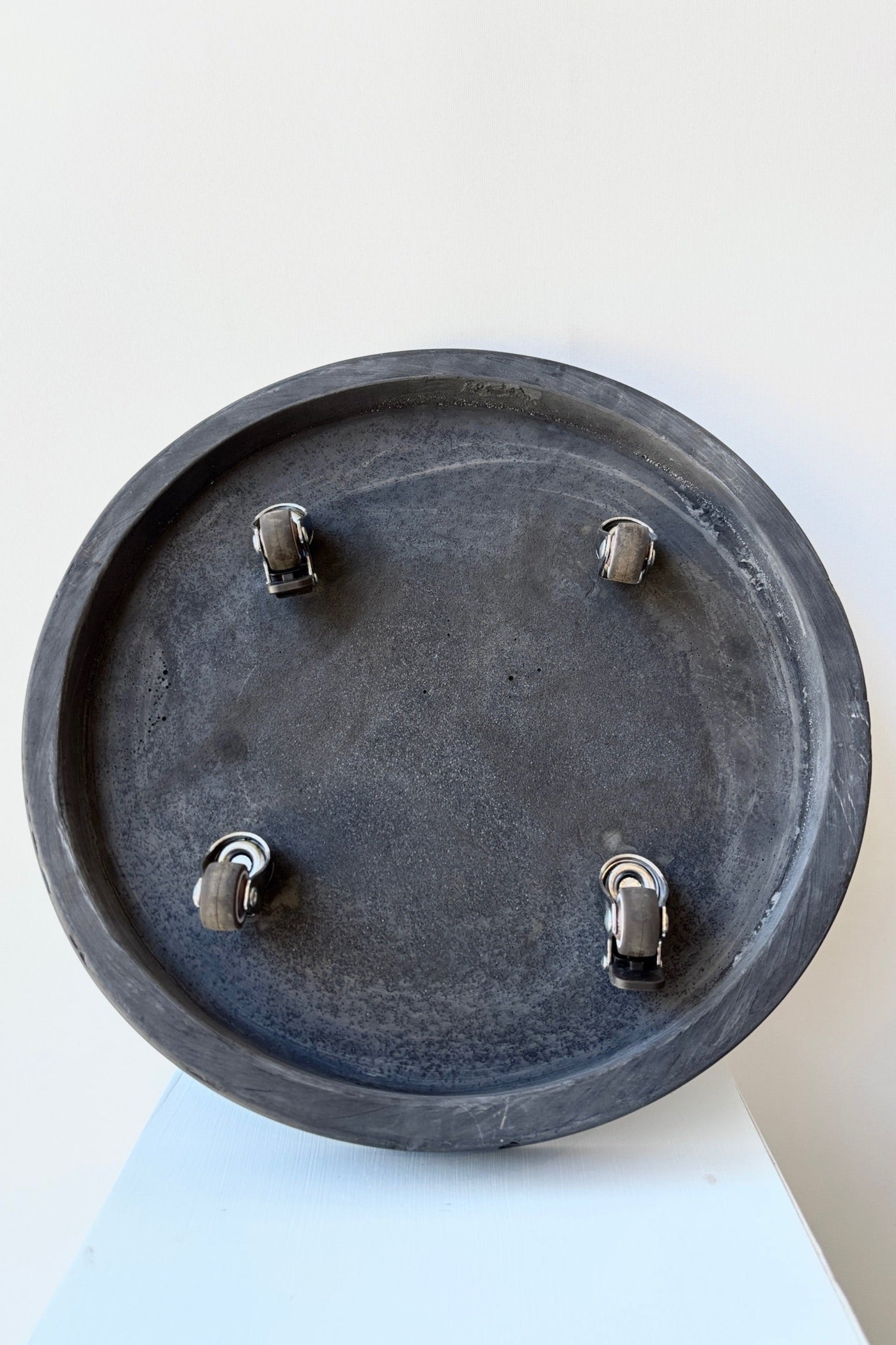 Underside of heavy duty terrazo plant trolley against a white background ©Sprout Home