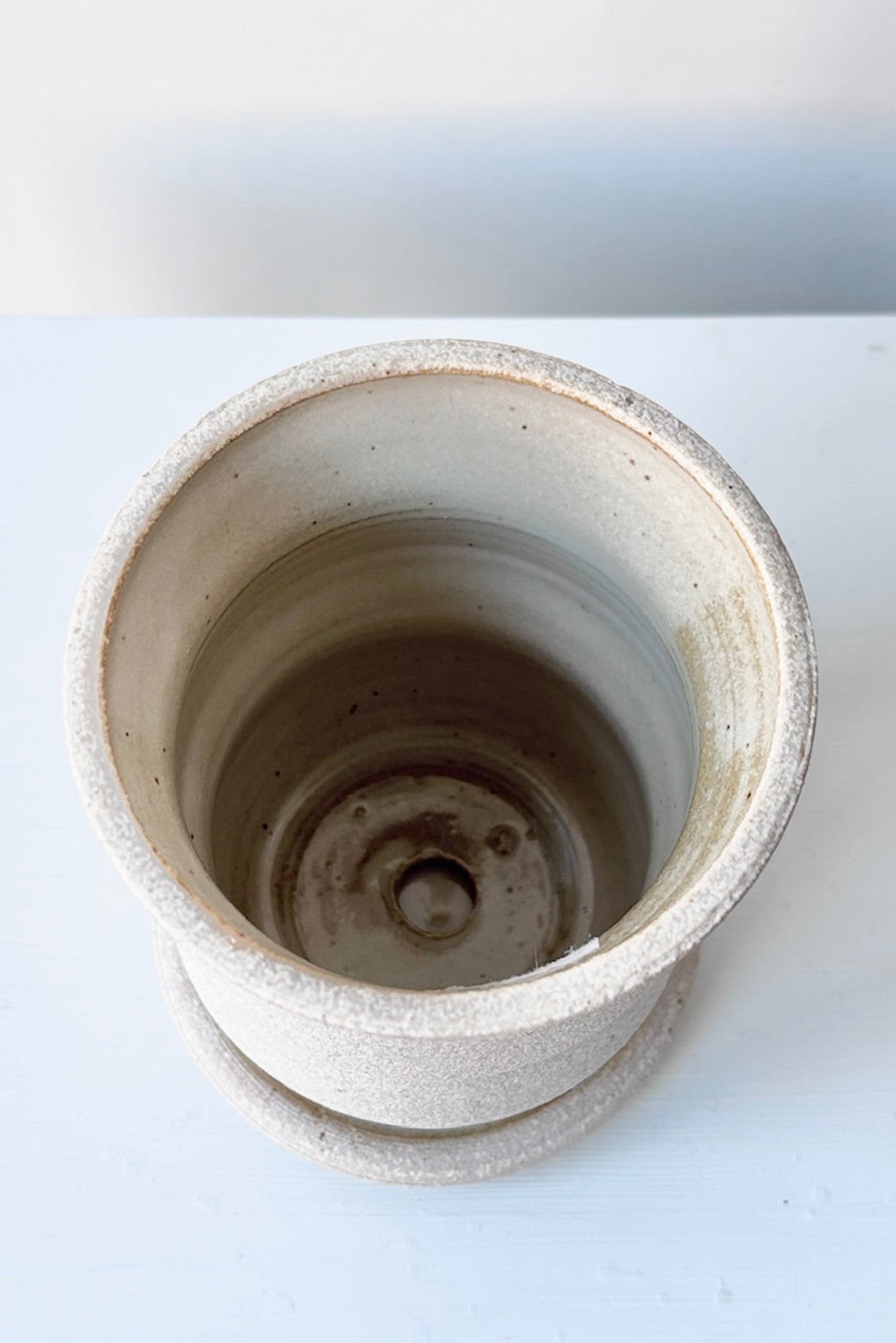 Overhead view of Creme Angled Planter by Olivia Snow Ceramics, displayed on a white surface ©Sprout Home