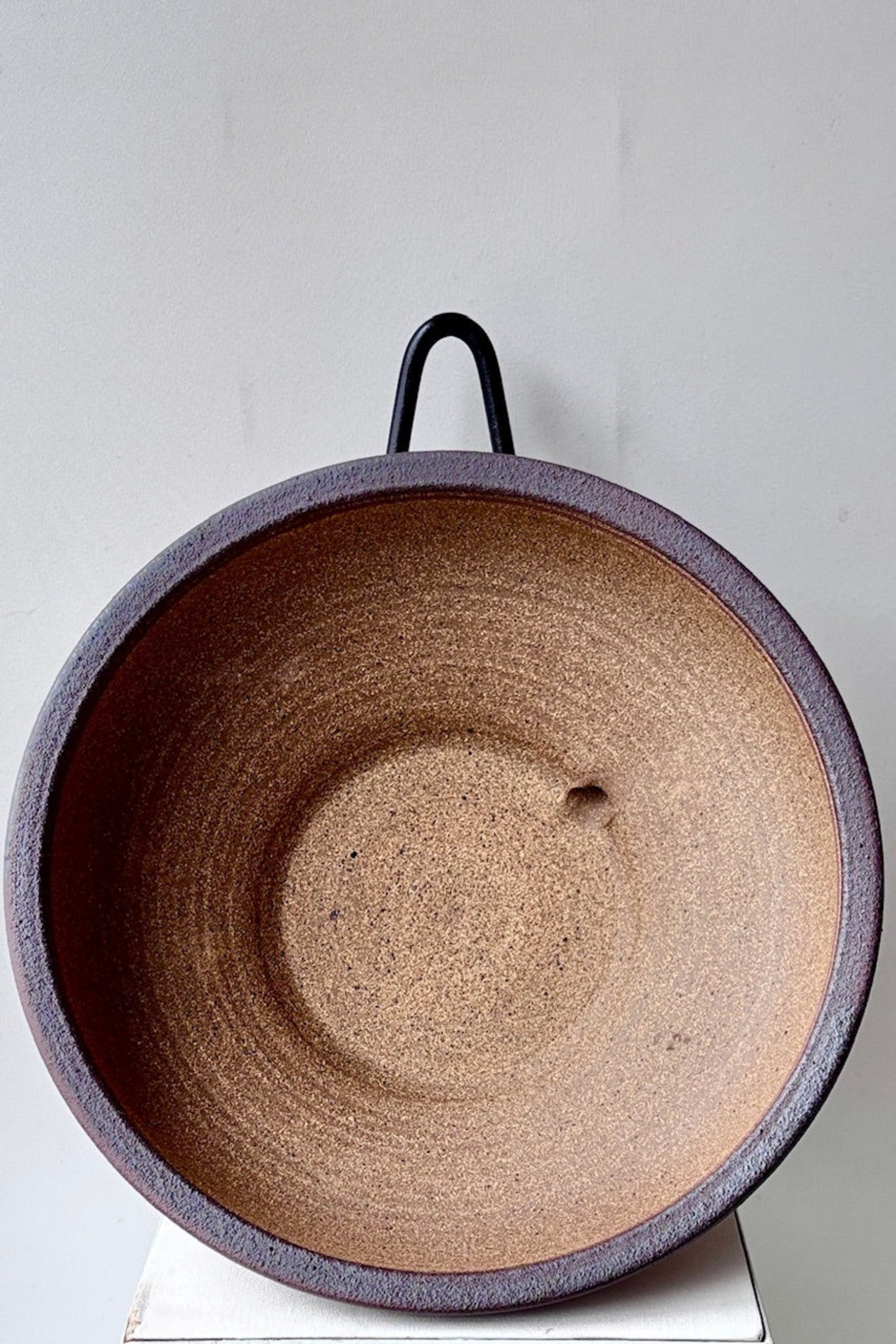 Unglazed large low bowl with textured pattern against a white surface ©Sprout Home