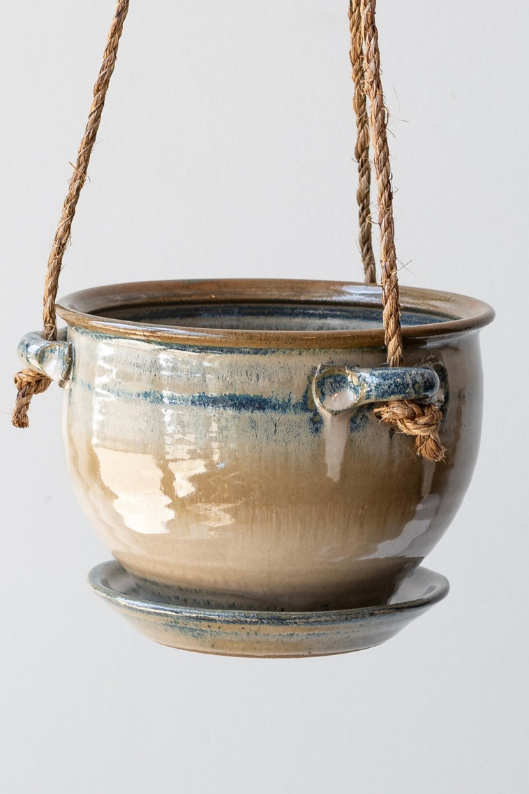 Detail of Bruning Pottery Hanging Planter ivory & iron glaze - 6" held in front of white wall