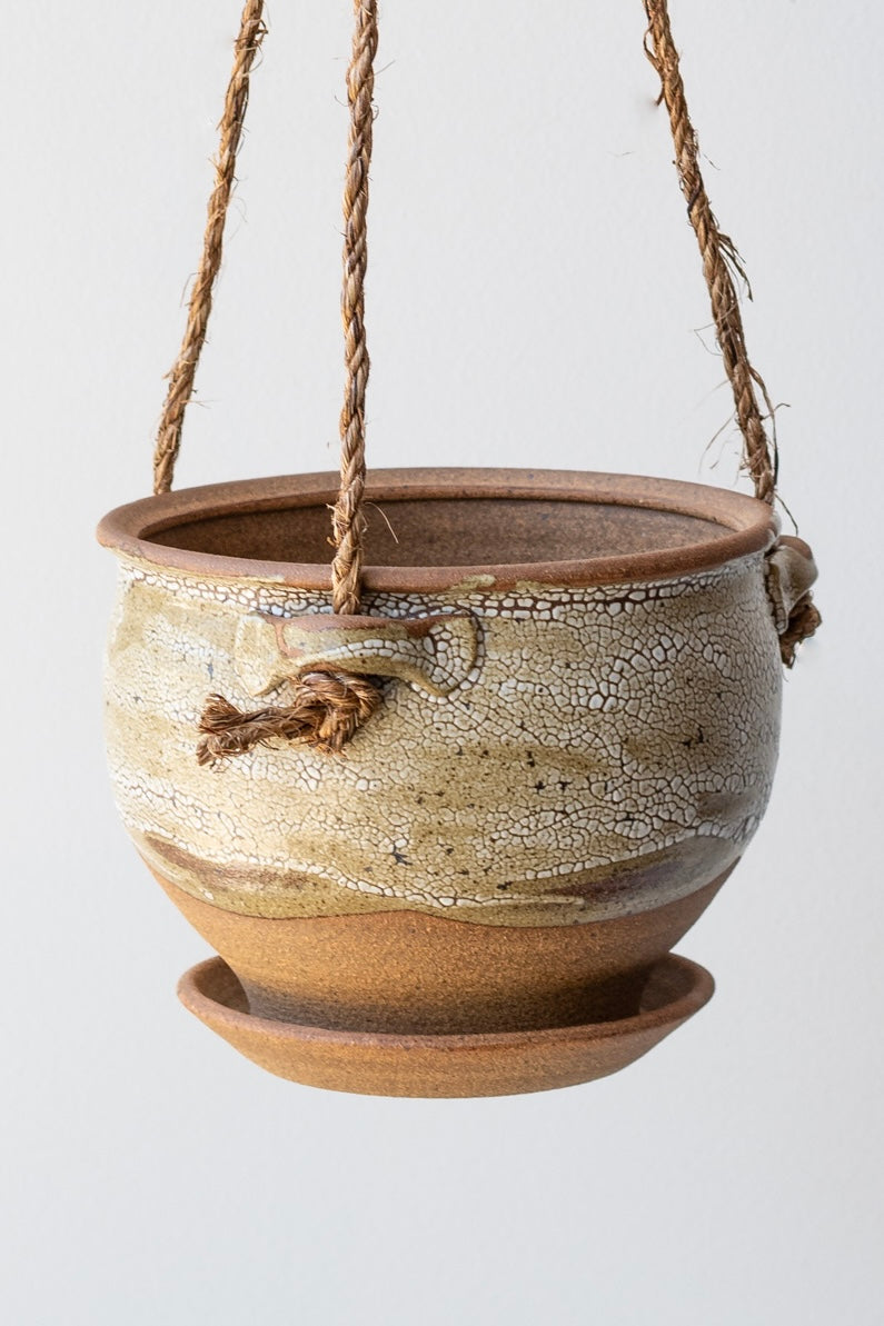Detail of Bruning Pottery Hanging Planter super crackle glaze - 6" held in front of white wall