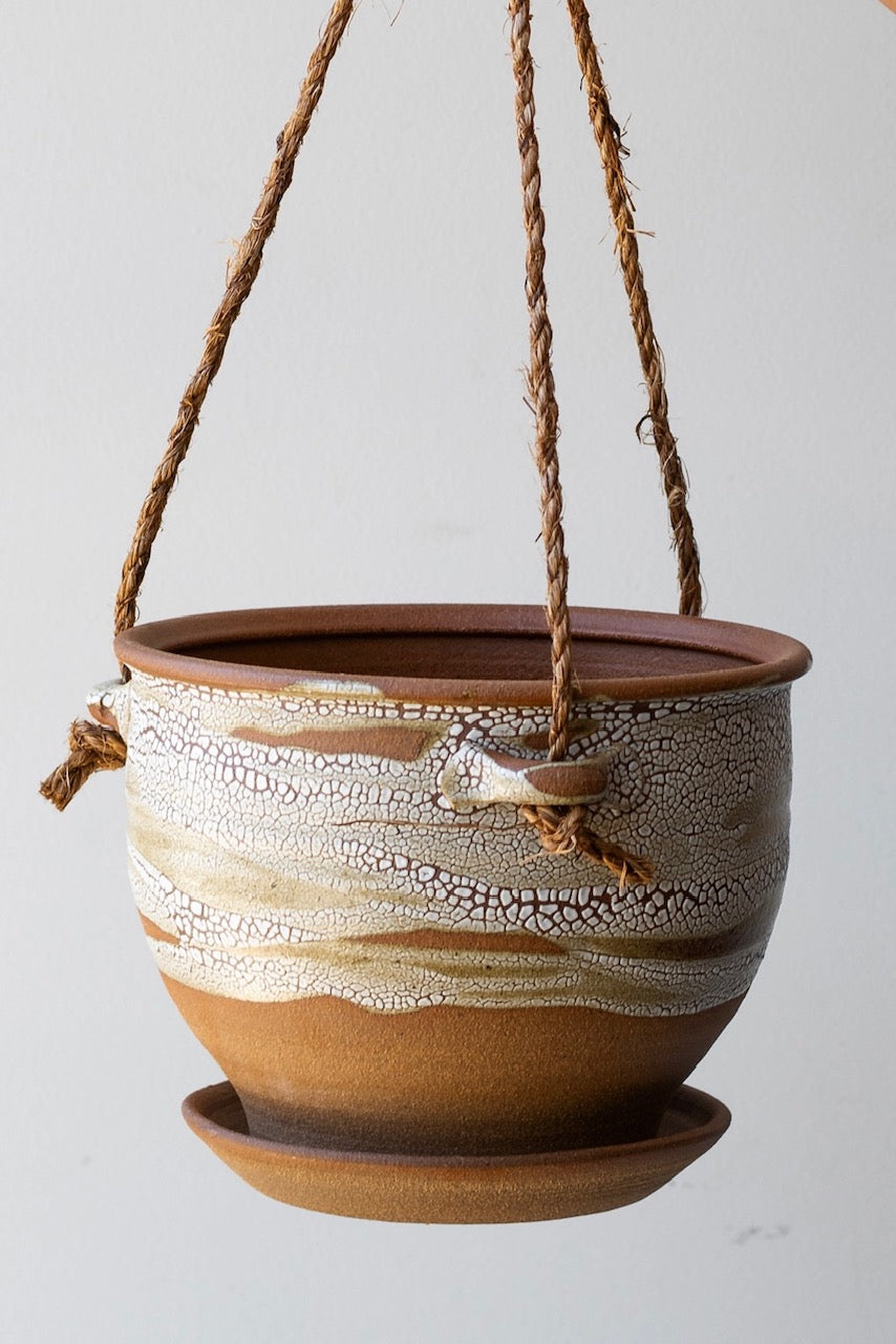 Detail of Bruning Pottery Hanging Planter super crackle glaze - 8" held in front of white wall