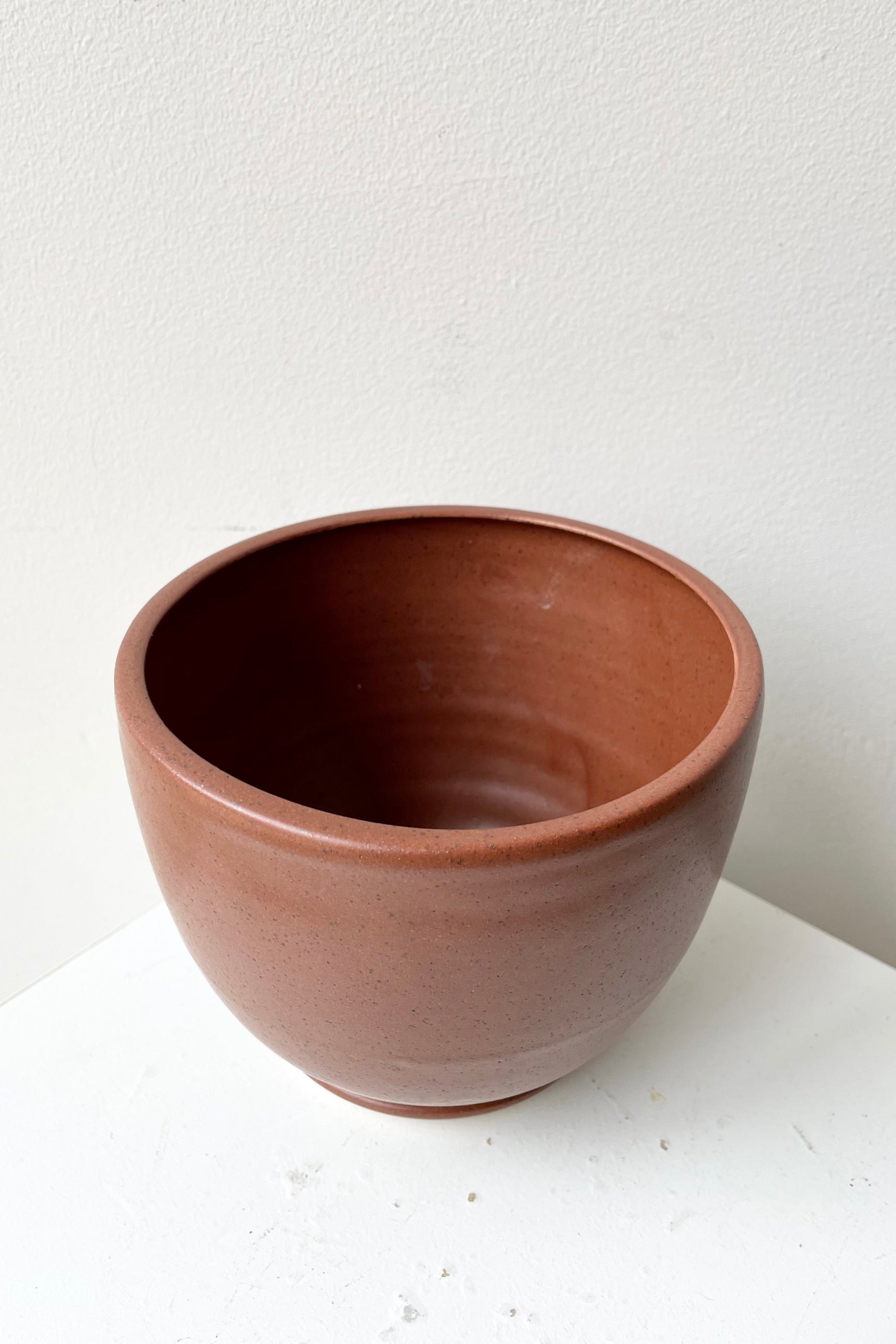 Tabletop Planter & Saucer medium in a Chocolate Speckle finish shown from above and the side looking in. ©Sprout Home