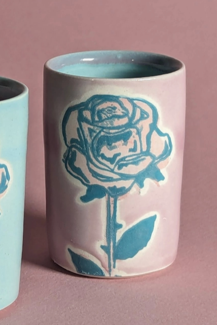 A purple ceramic shot glass with a rose pattern on the glaze ©City In Bloom Ceramics