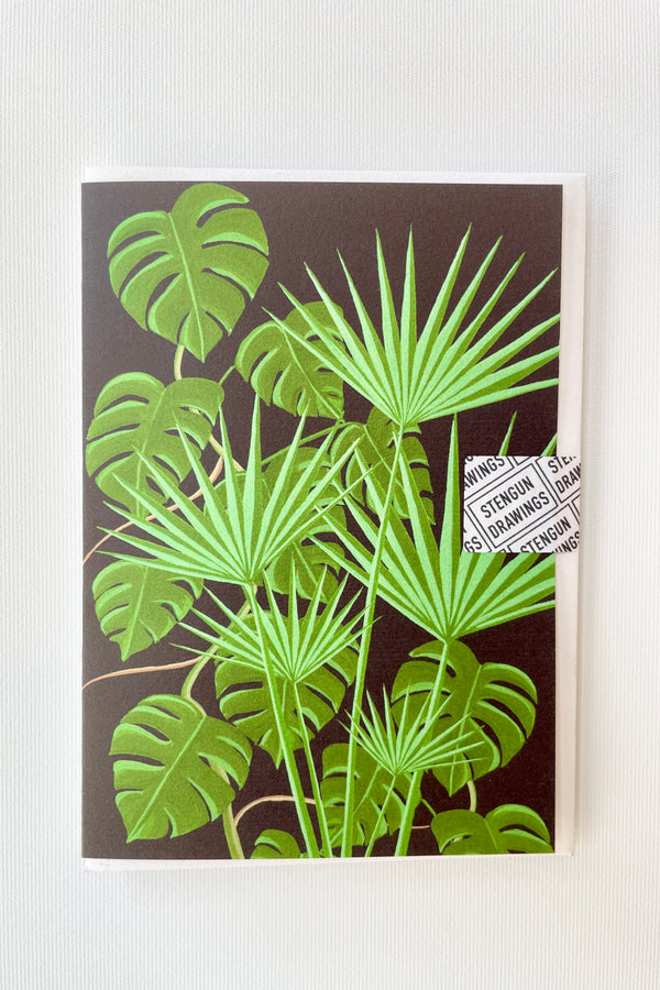 The Lost Glasshouse greeting card by Stengun Drawings showing the whole card front on a white wall. 
