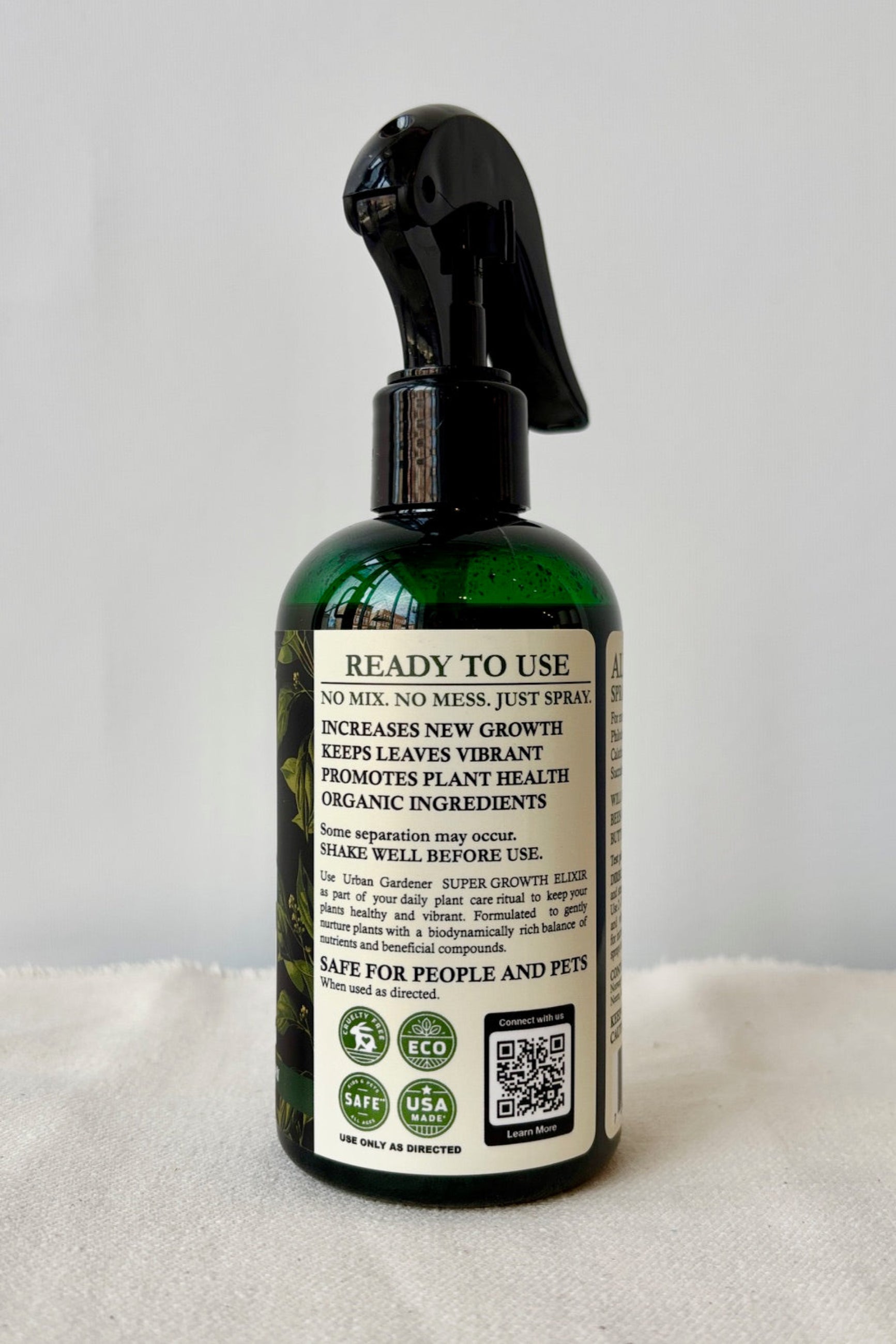 Backside of Urban Gardeners Growth Elixer in a green spray bottle against a white background ©Sprout Home